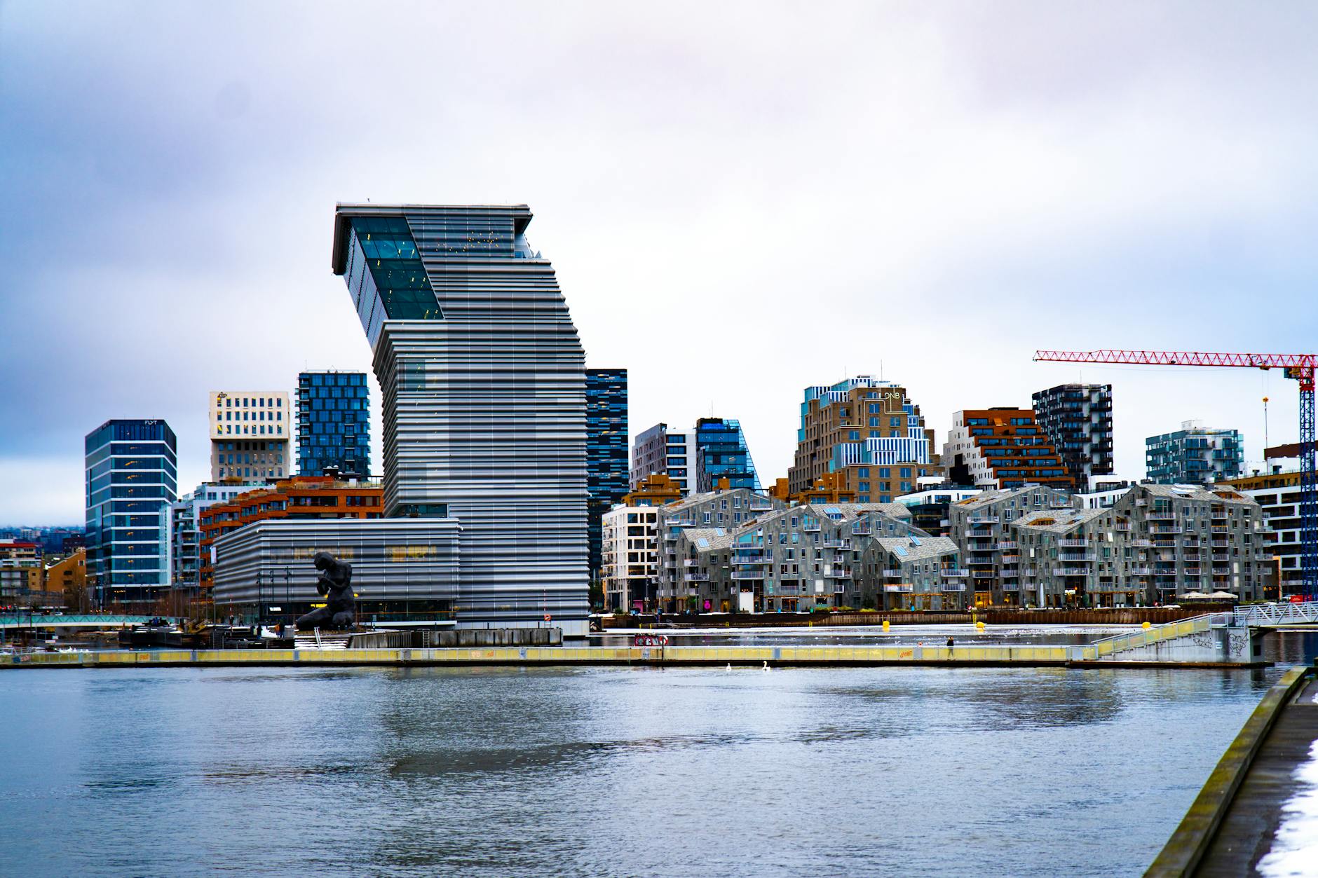 Oslo waterfront with modern architecture under cloudy sky