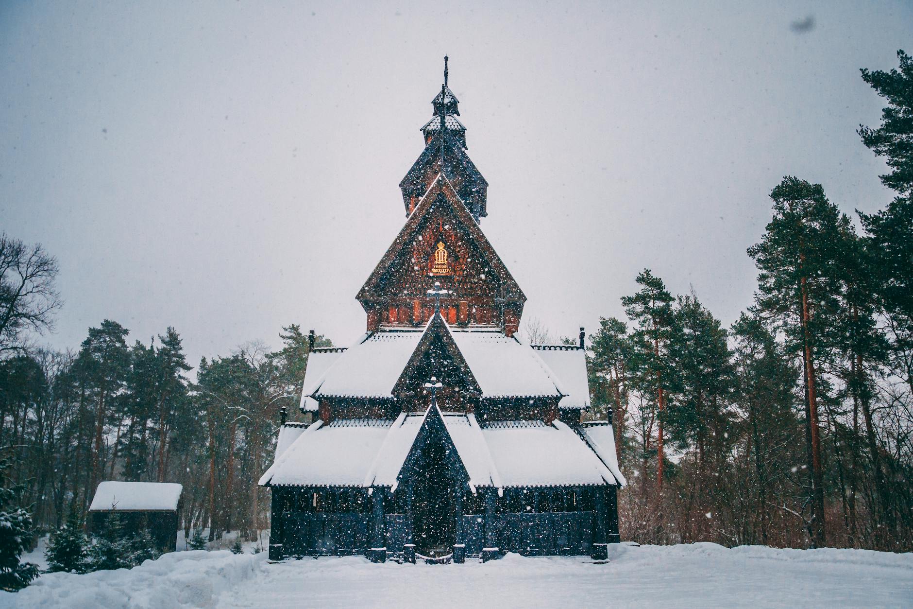 Snow-covered stave church in Oslo during winter
