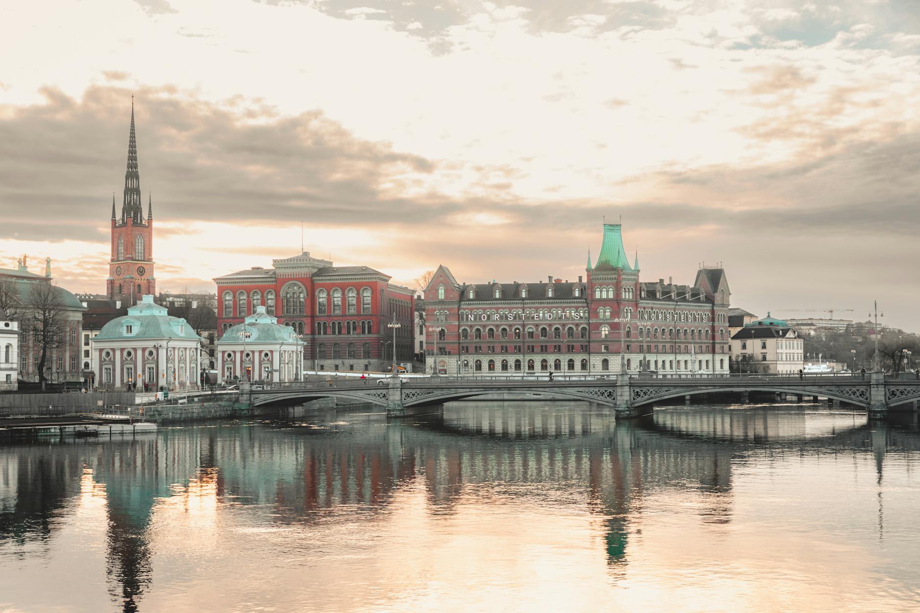 Oslo historic riverside with reflections under dramatic sky