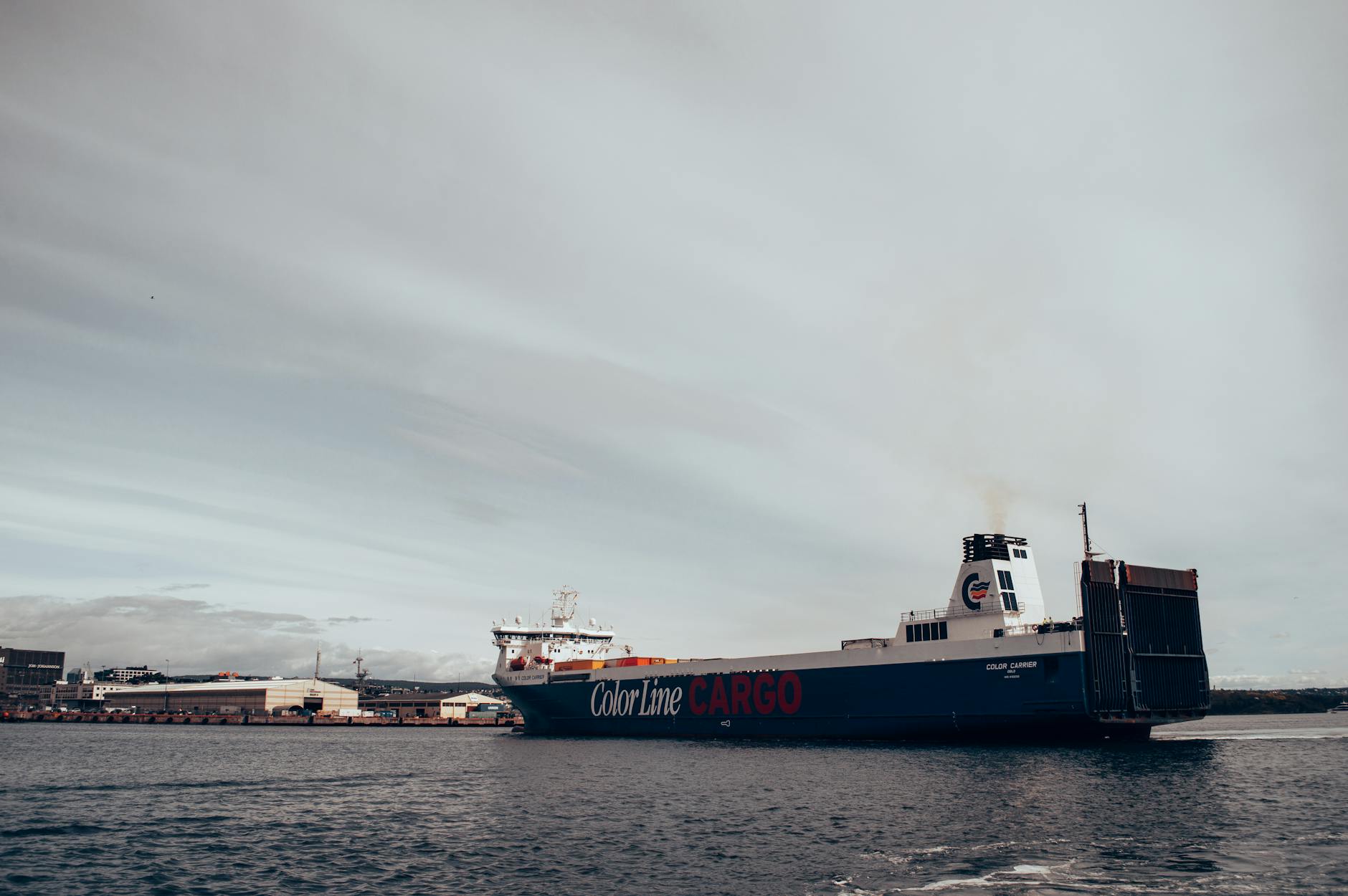 Cargo ship in Oslo harbor under a cloudy sky