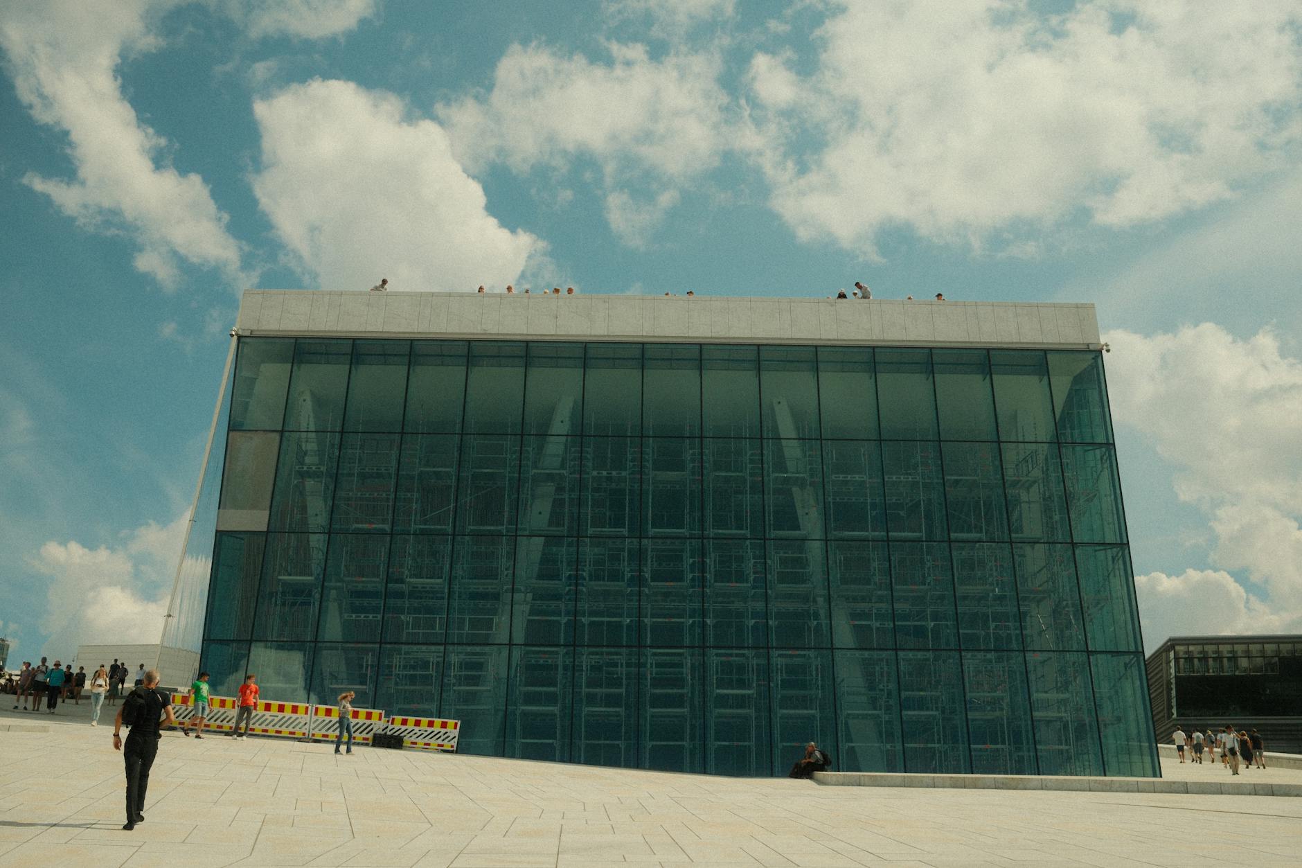 Oslo Opera House glass facade with visitors outside