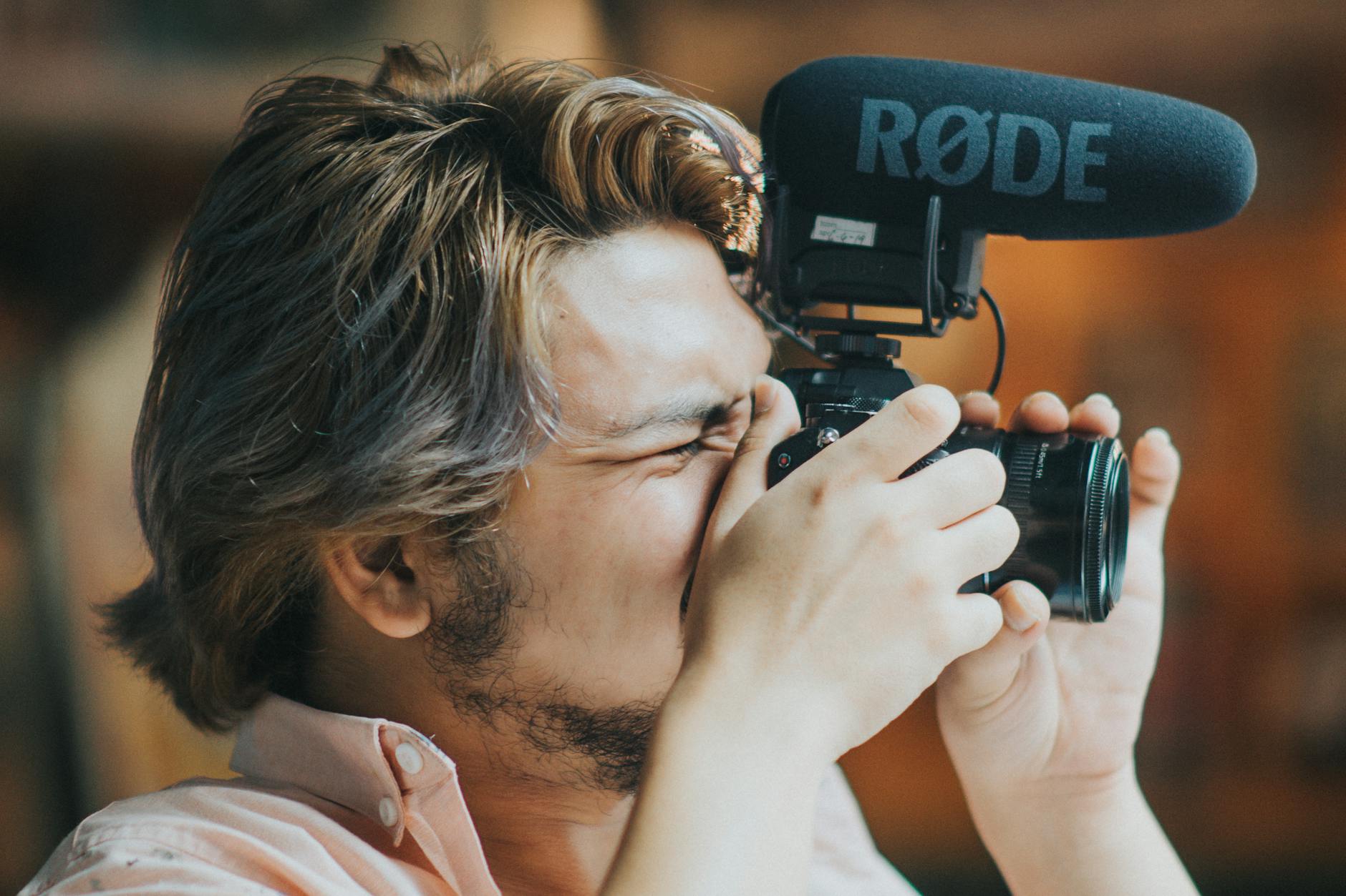 Photographer working with mounted microphone and camera