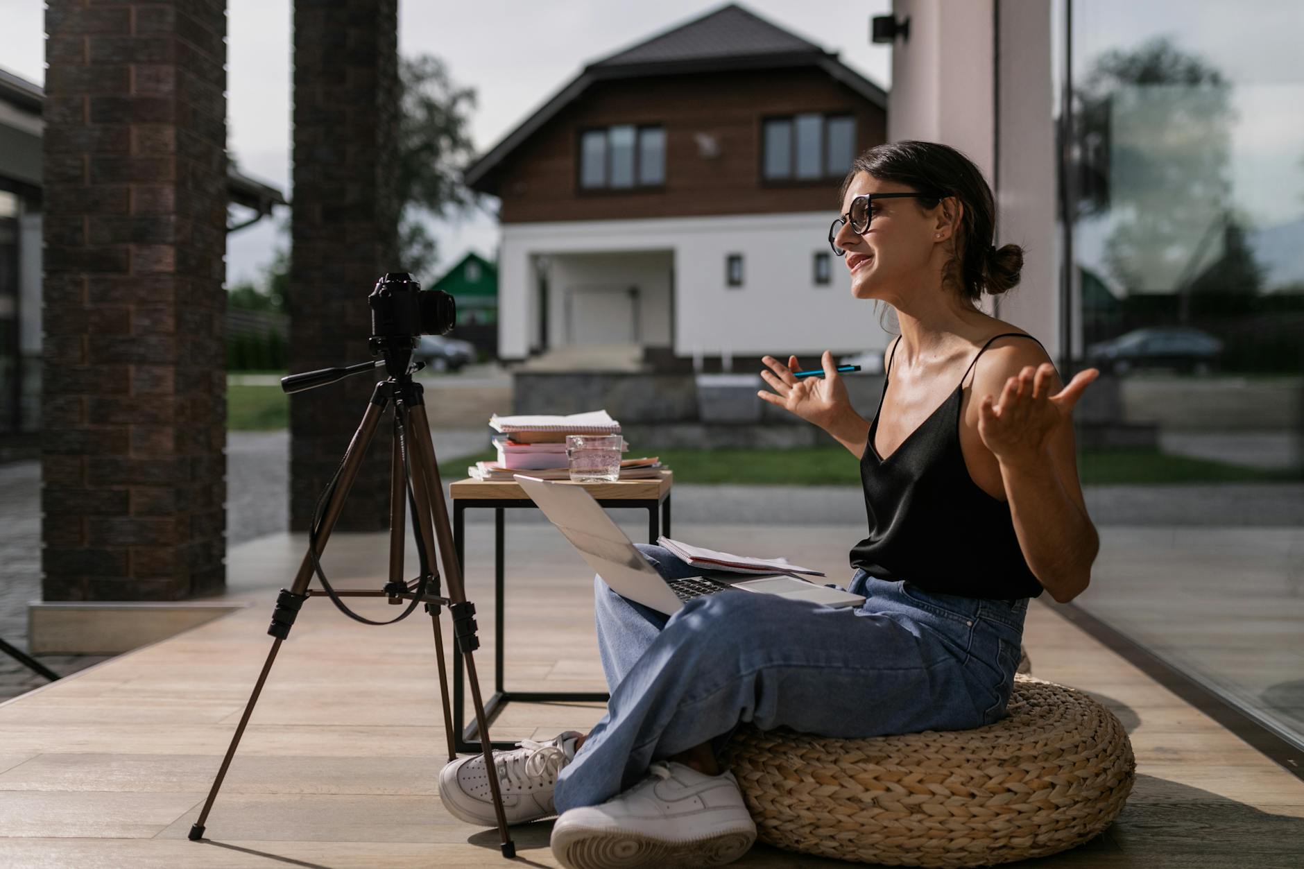 Creator filming outdoors with laptop and tripod camera setup