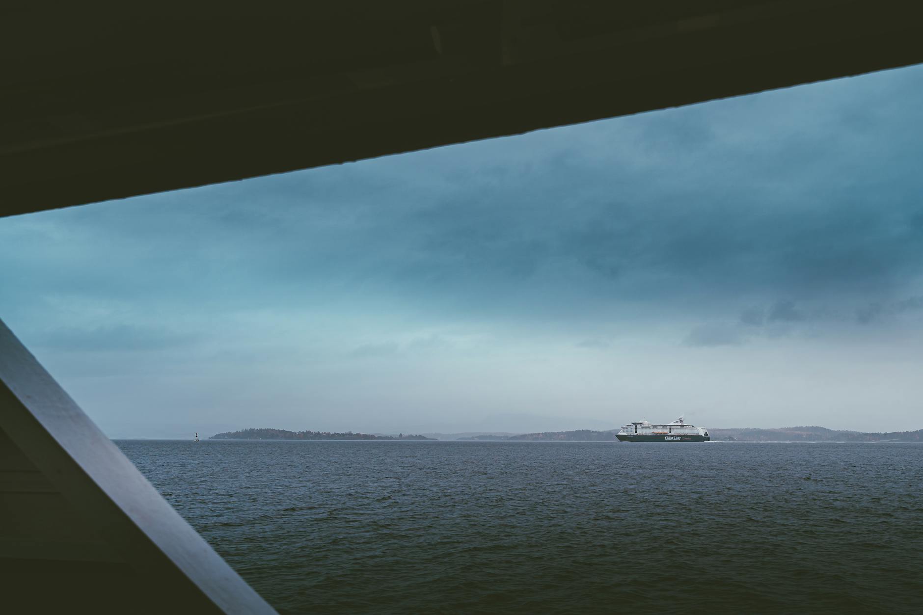 Ferry sailing on Oslofjord under a cloudy sky