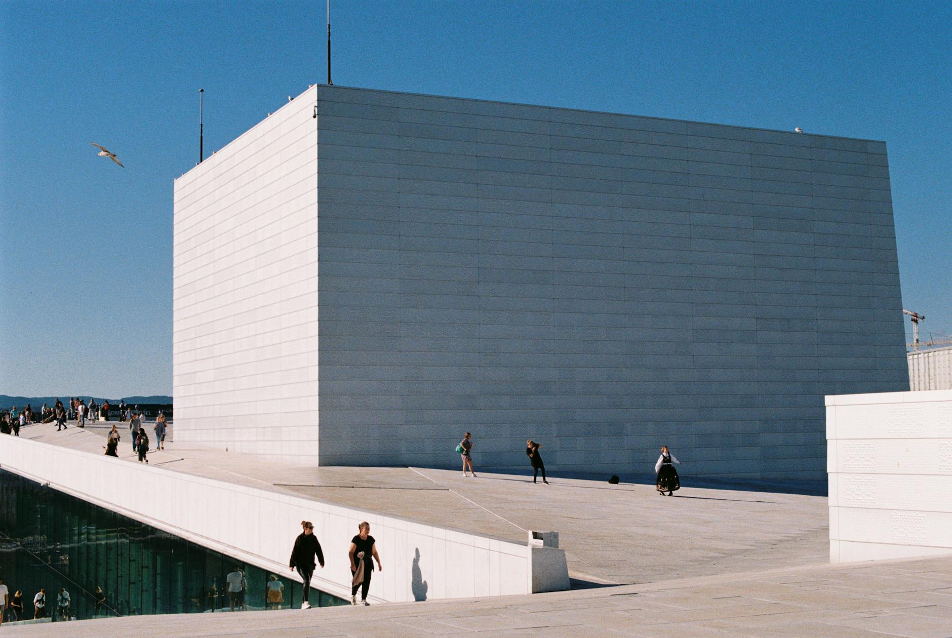 Visitors outside Oslo Opera House on a clear winter day