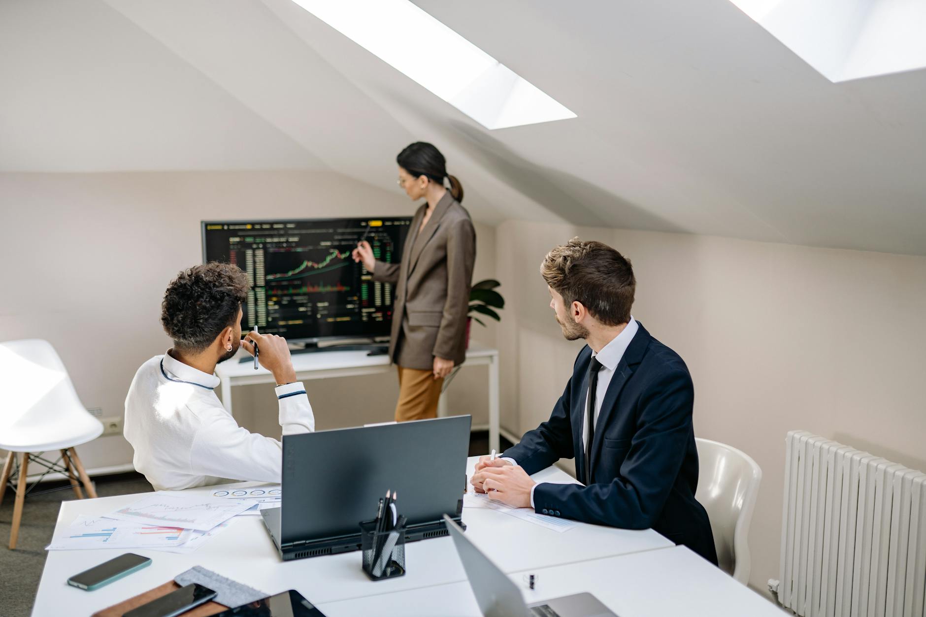 Professionals reviewing stock market charts in an office