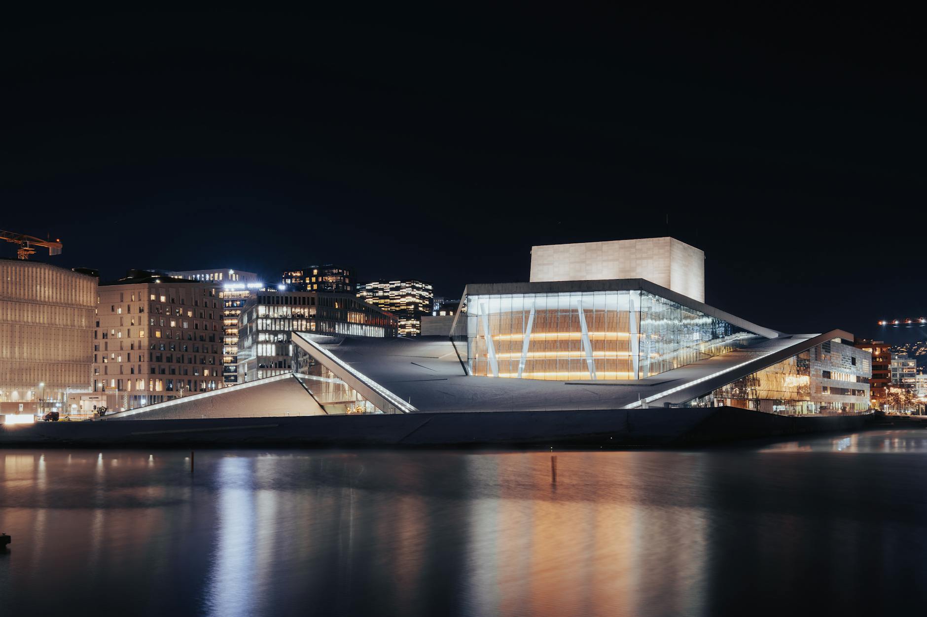 Oslo Opera House illuminated at night with water reflections