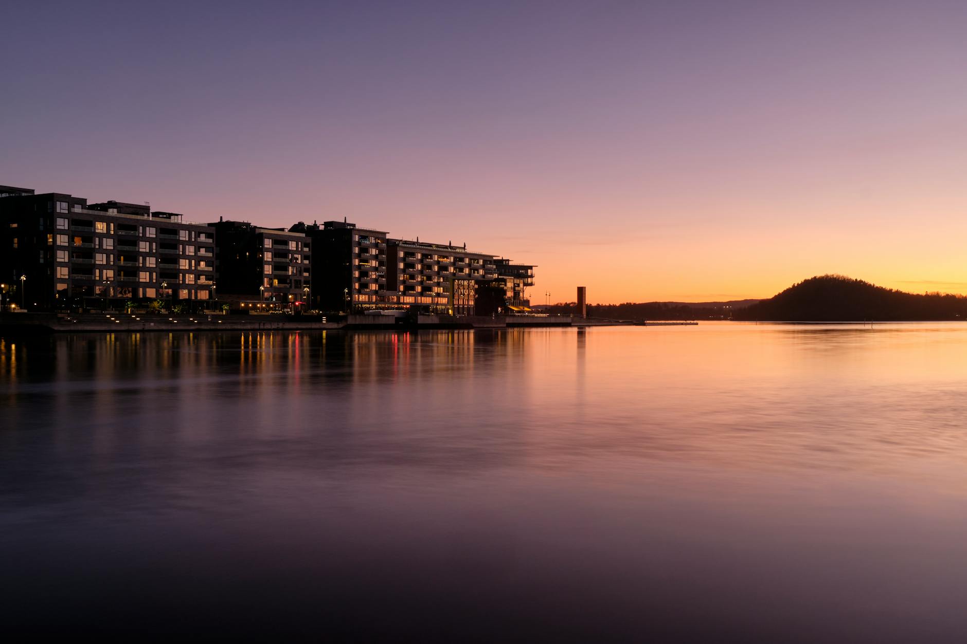 Oslo waterfront at sunset reflected over calm water