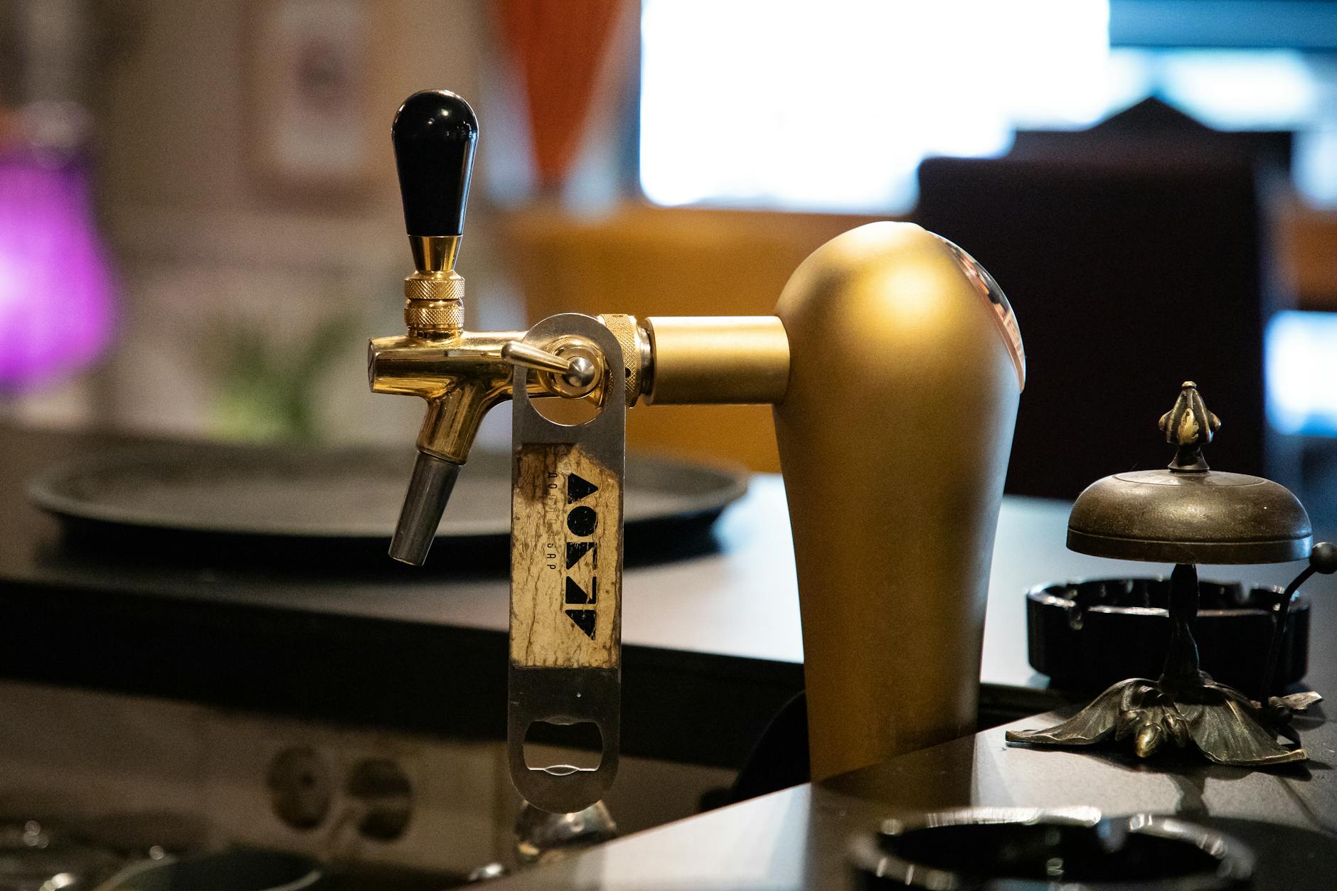 Close-up of a golden beer tap in a bar