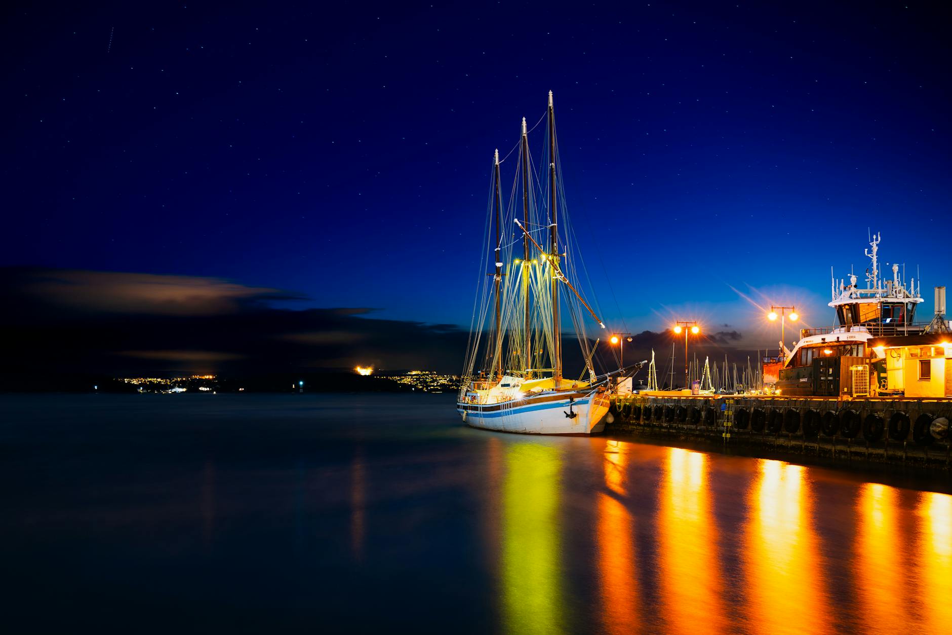 Illuminated sailboat in Oslo harbor at night