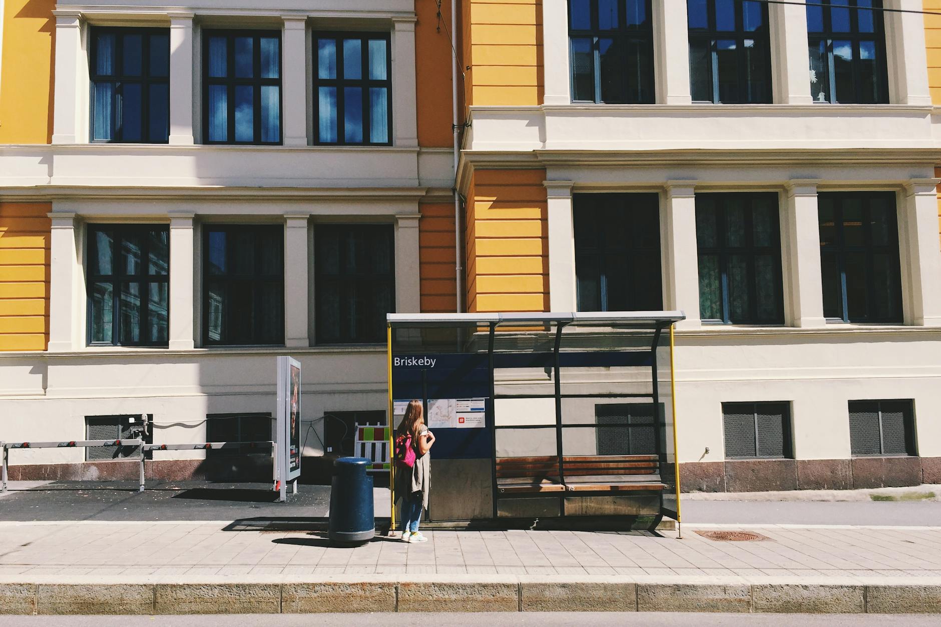Traveler waiting at a Briskeby bus stop in Oslo
