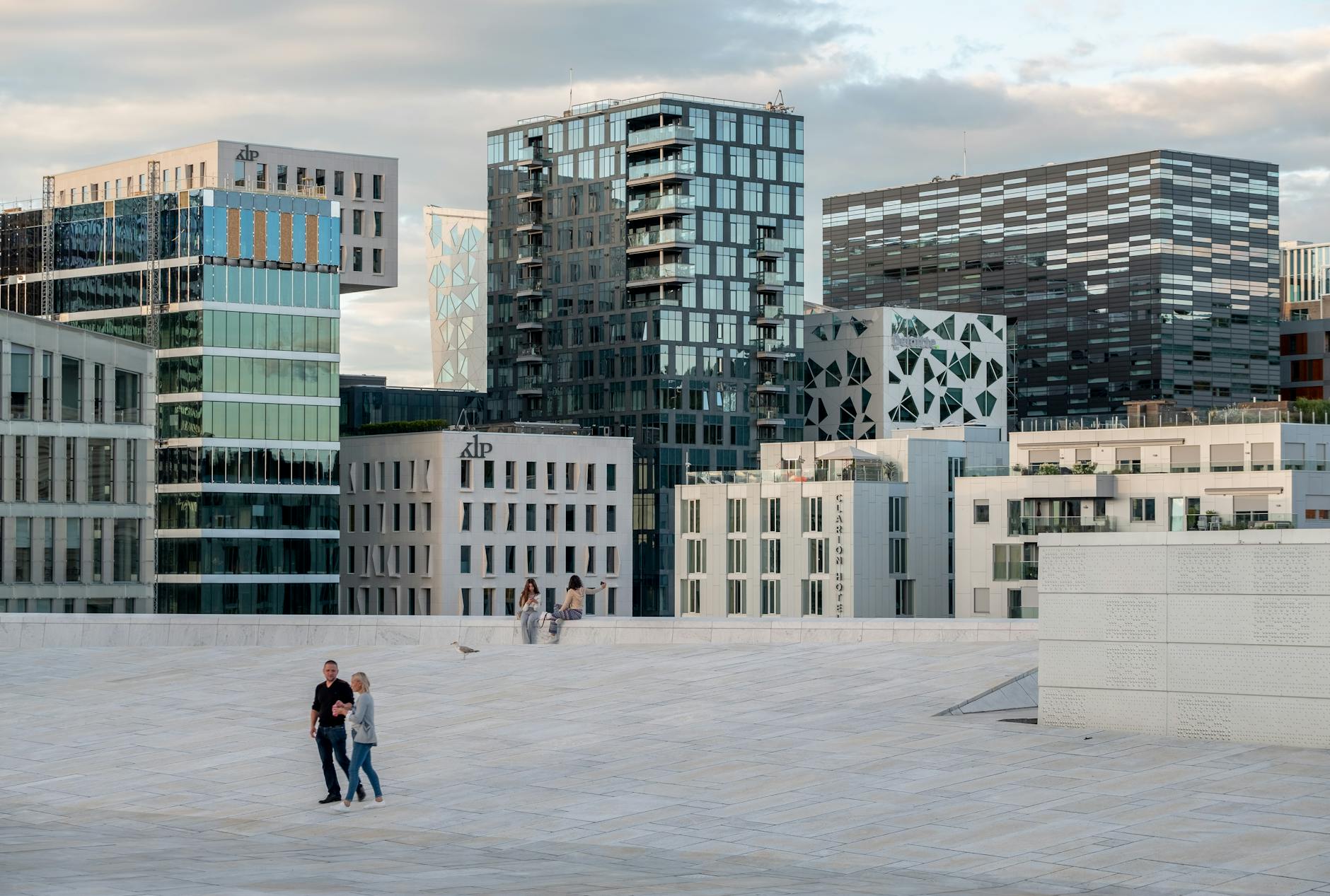 People walking through a modern Oslo cityscape