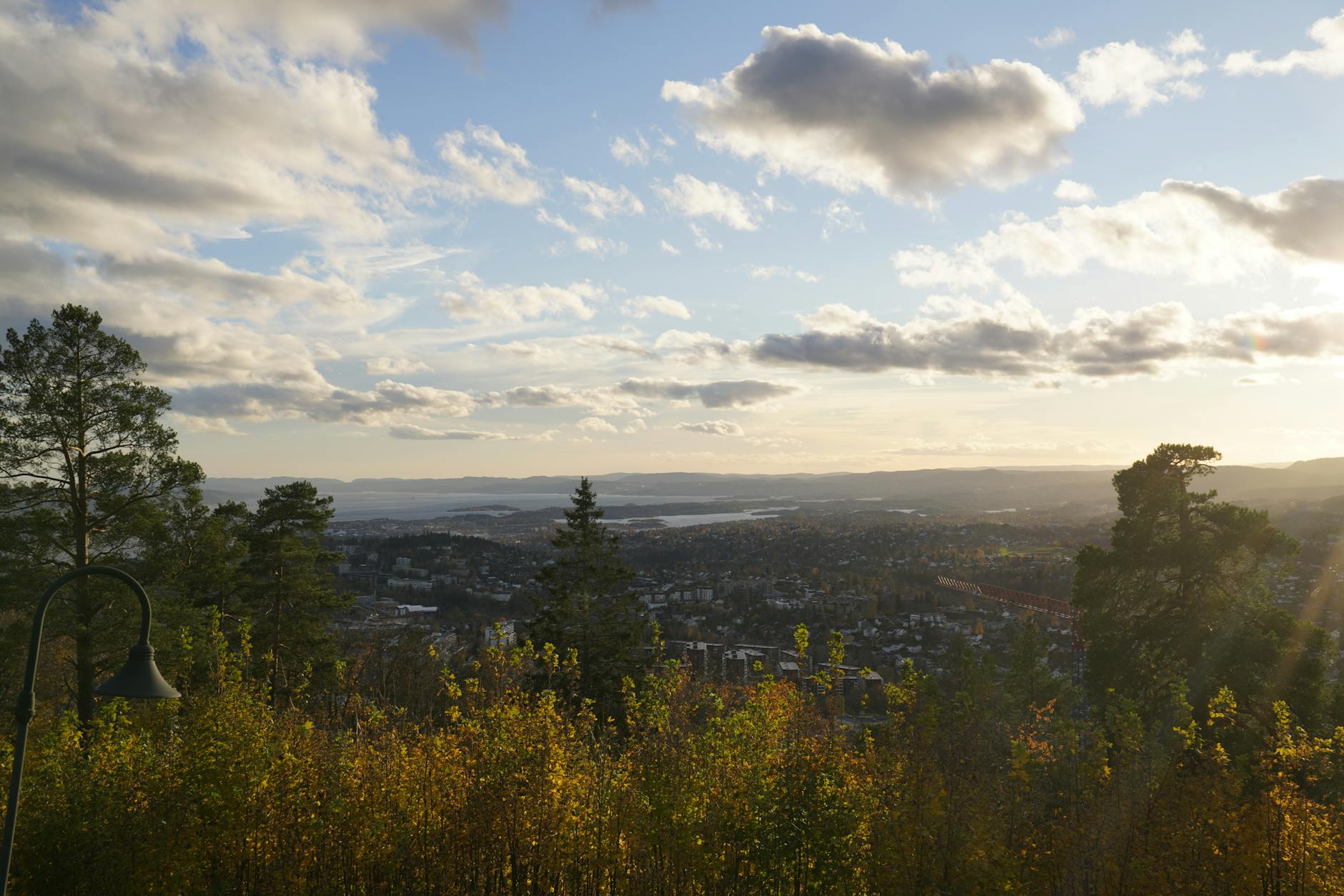 City surrounded by trees and hills at sunset