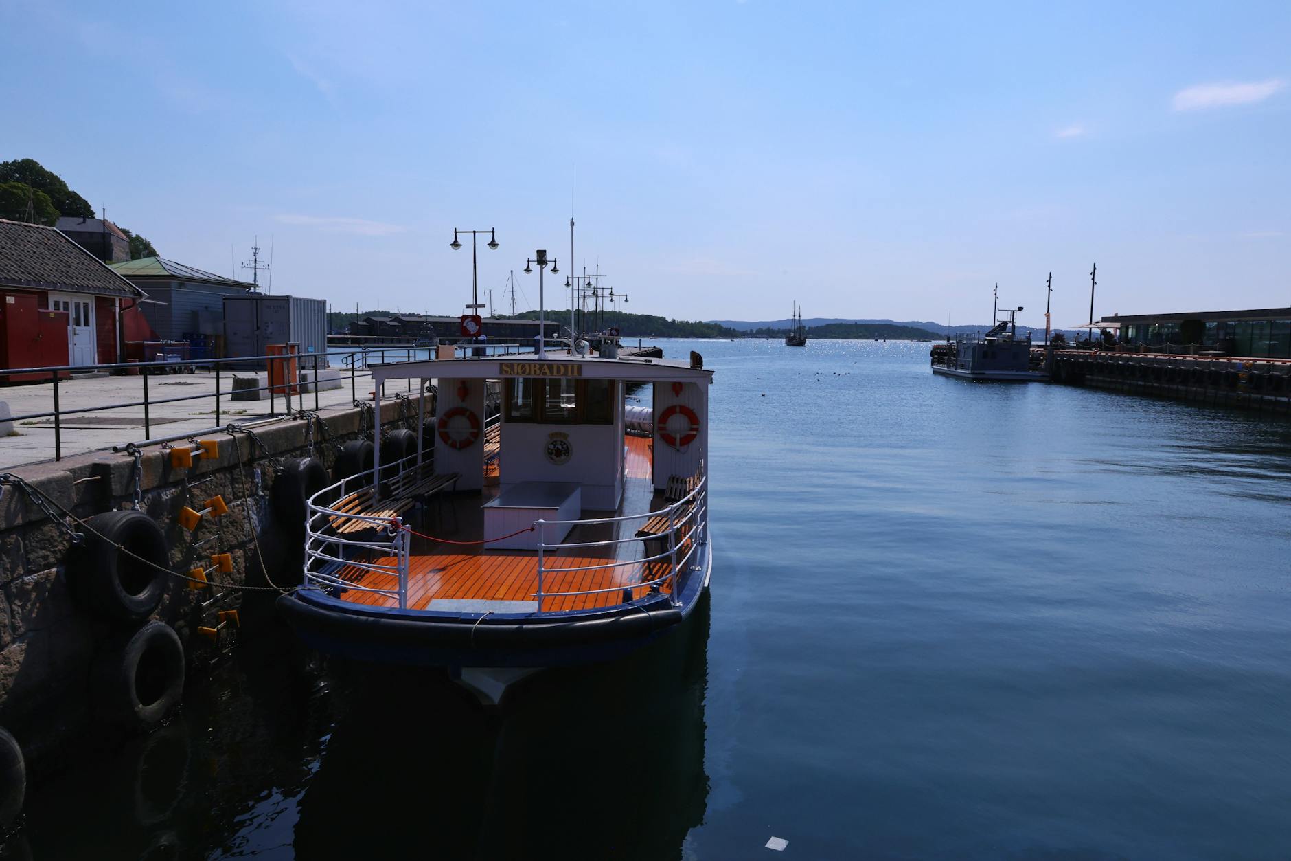 Boat docked at Oslo harbor on a sunny day