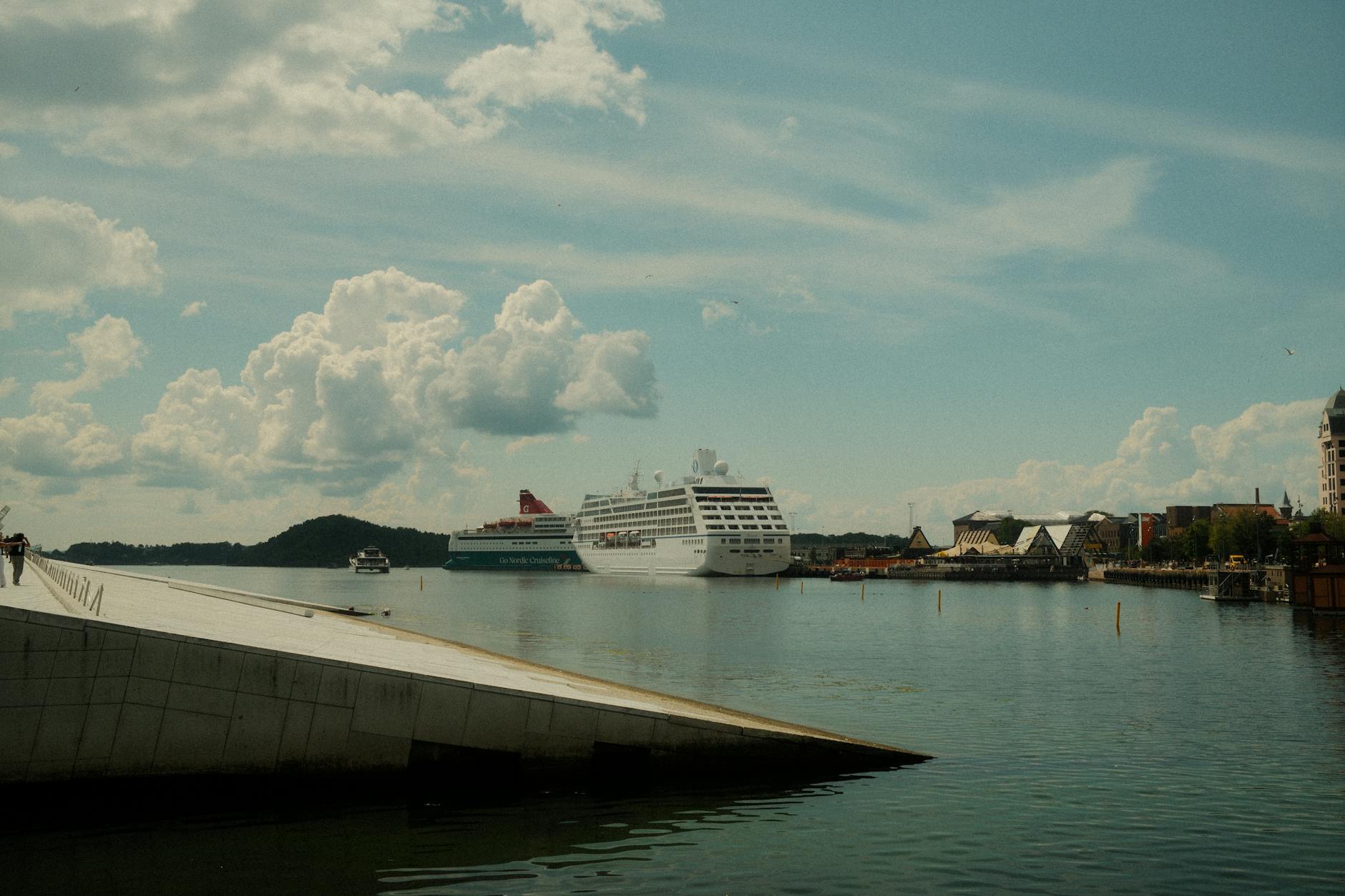 Oslo harbor with ships under a cloudy sky