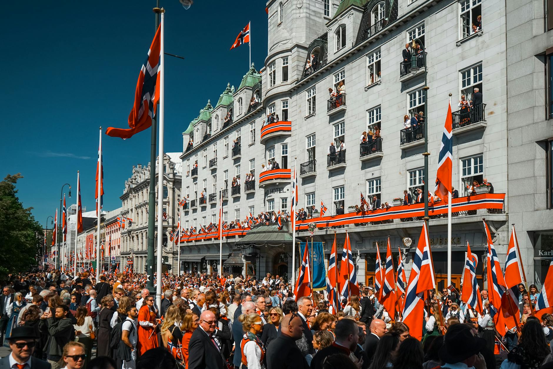 Street celebration in Oslo with people and flags