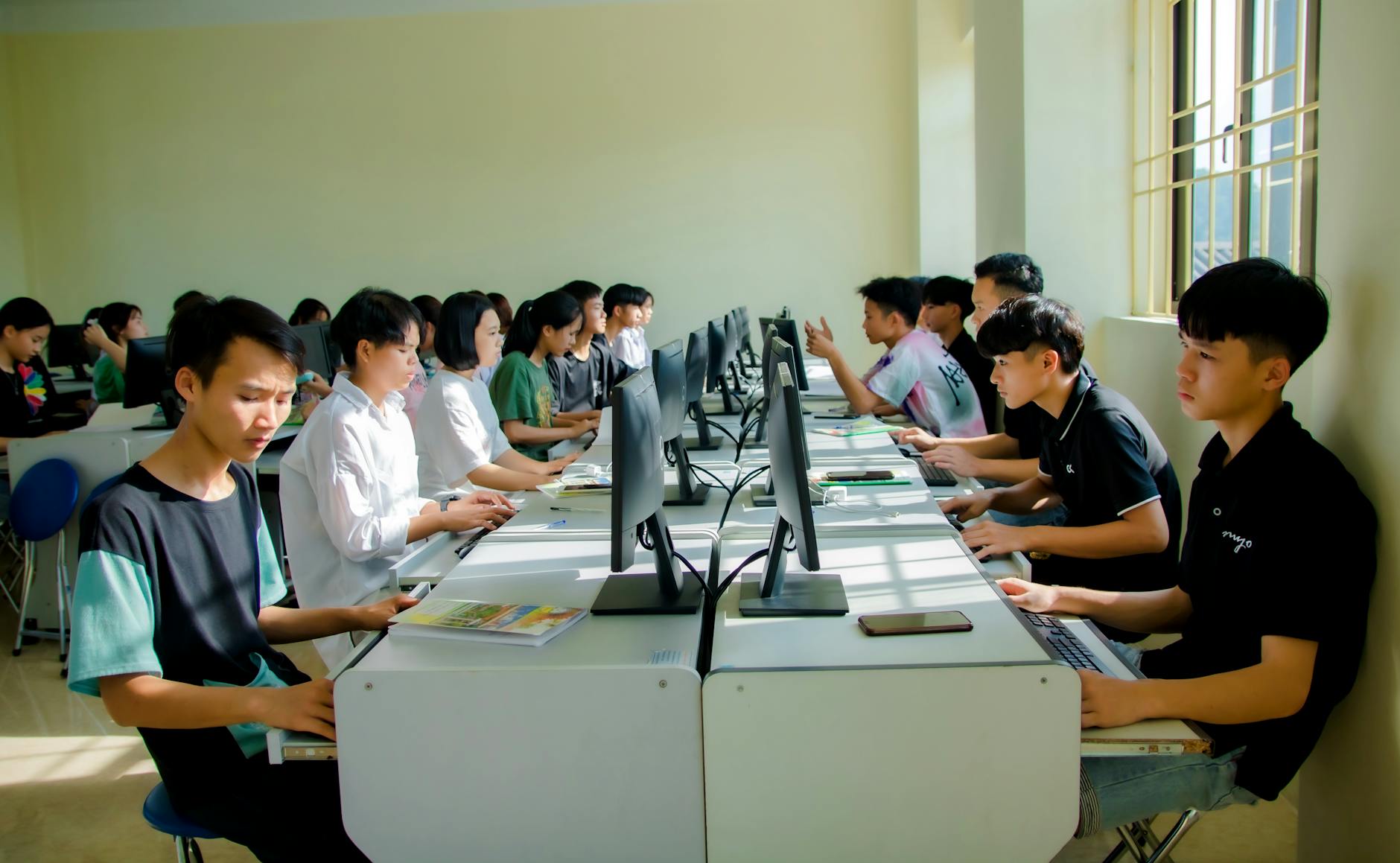 Students focused on computer tasks in a classroom