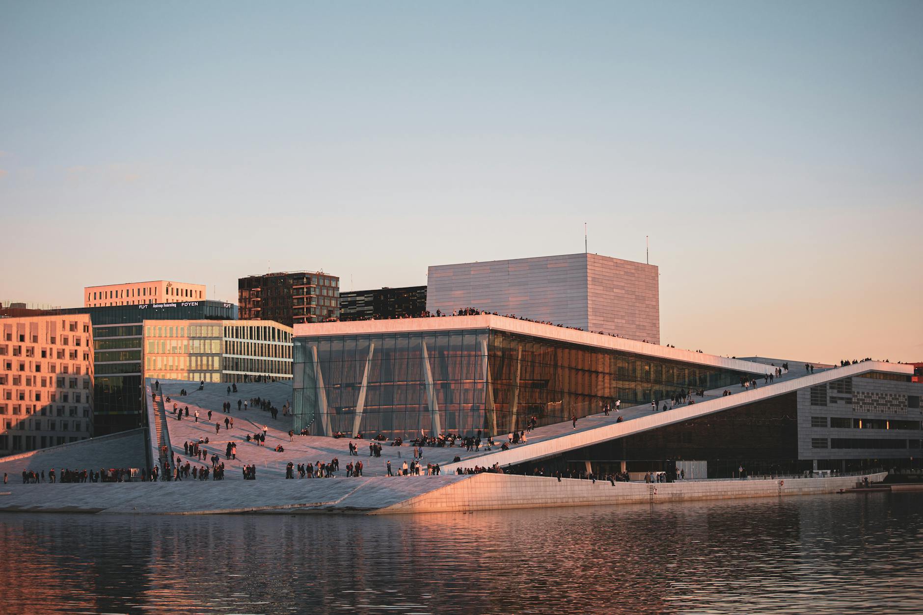Oslo Opera House reflected in water at sunset