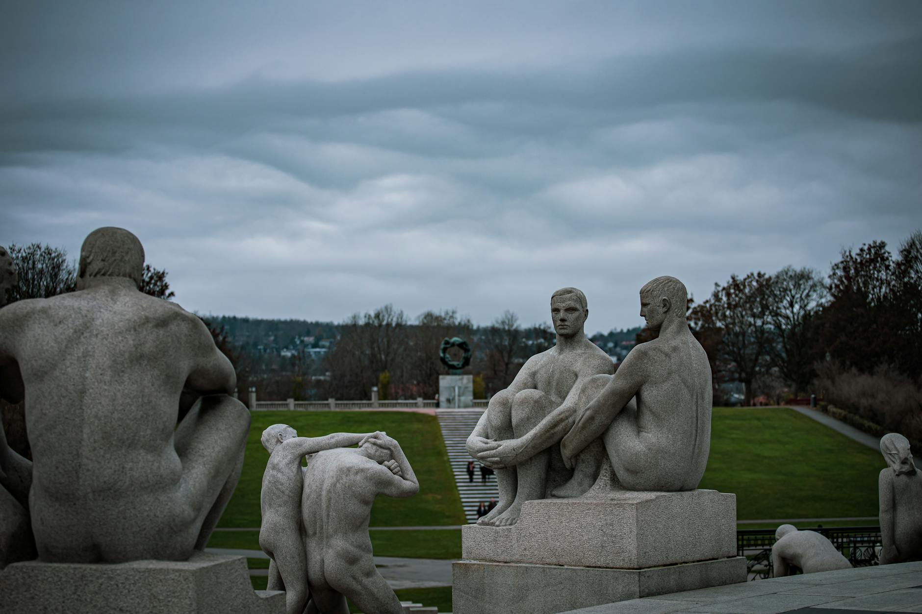 Granite sculptures in Vigeland Park under an overcast sky