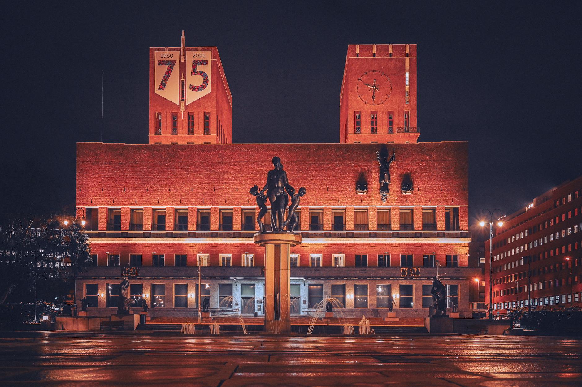 Oslo City Hall at night with illuminated statue