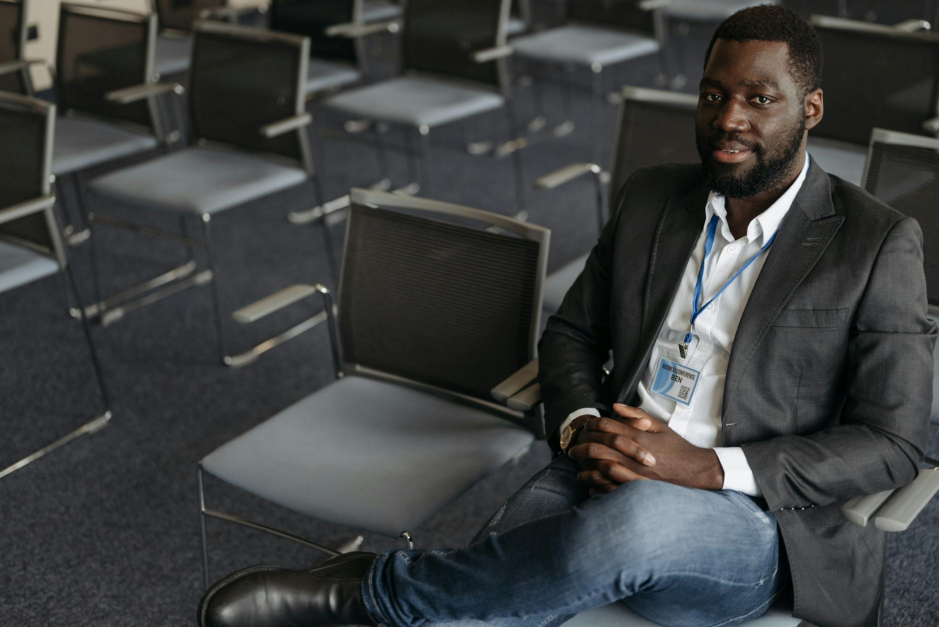Business attendee wearing a badge in a conference room