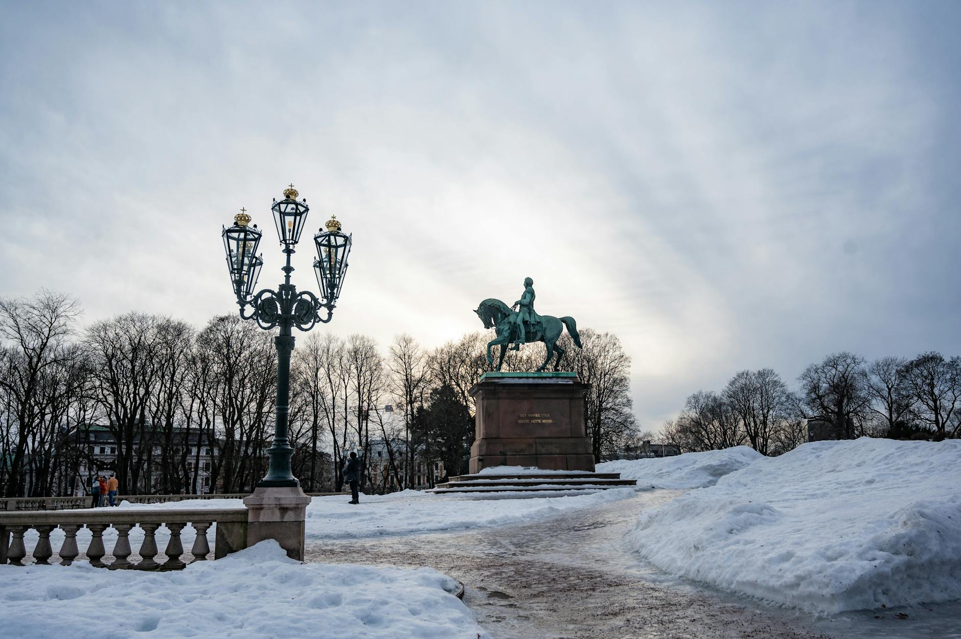 Snowy Oslo park with equestrian statue