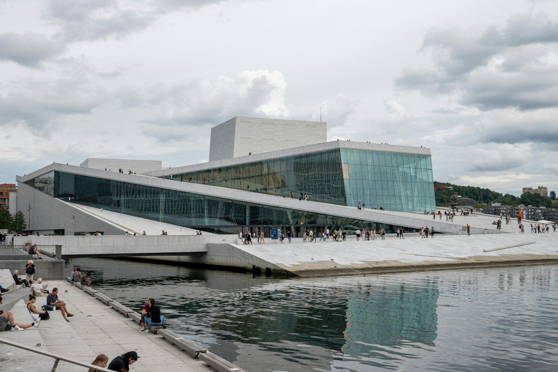 Oslo Opera House and waterfront under dramatic sky