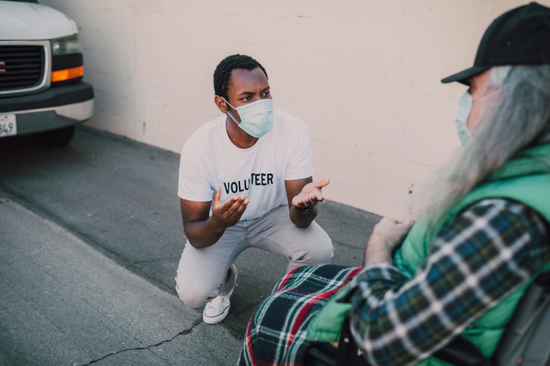 Volunteer speaking with a community member outdoors