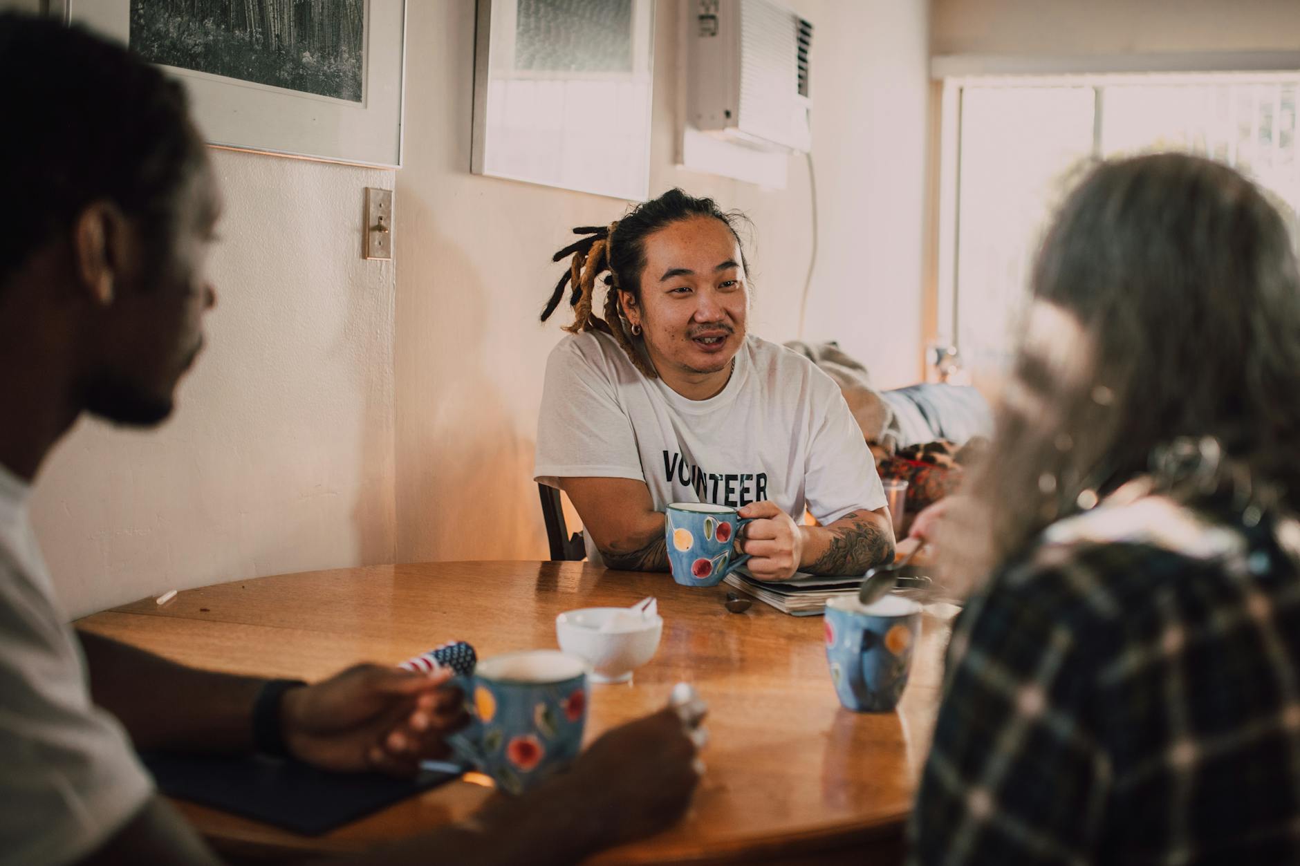 Volunteers talking together over coffee indoors