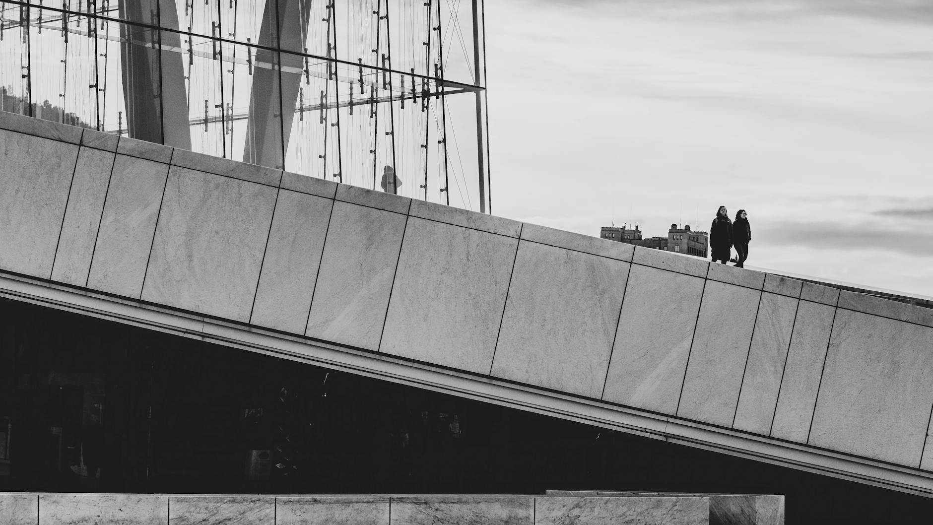 People walking across the modern slope of Oslo Opera House