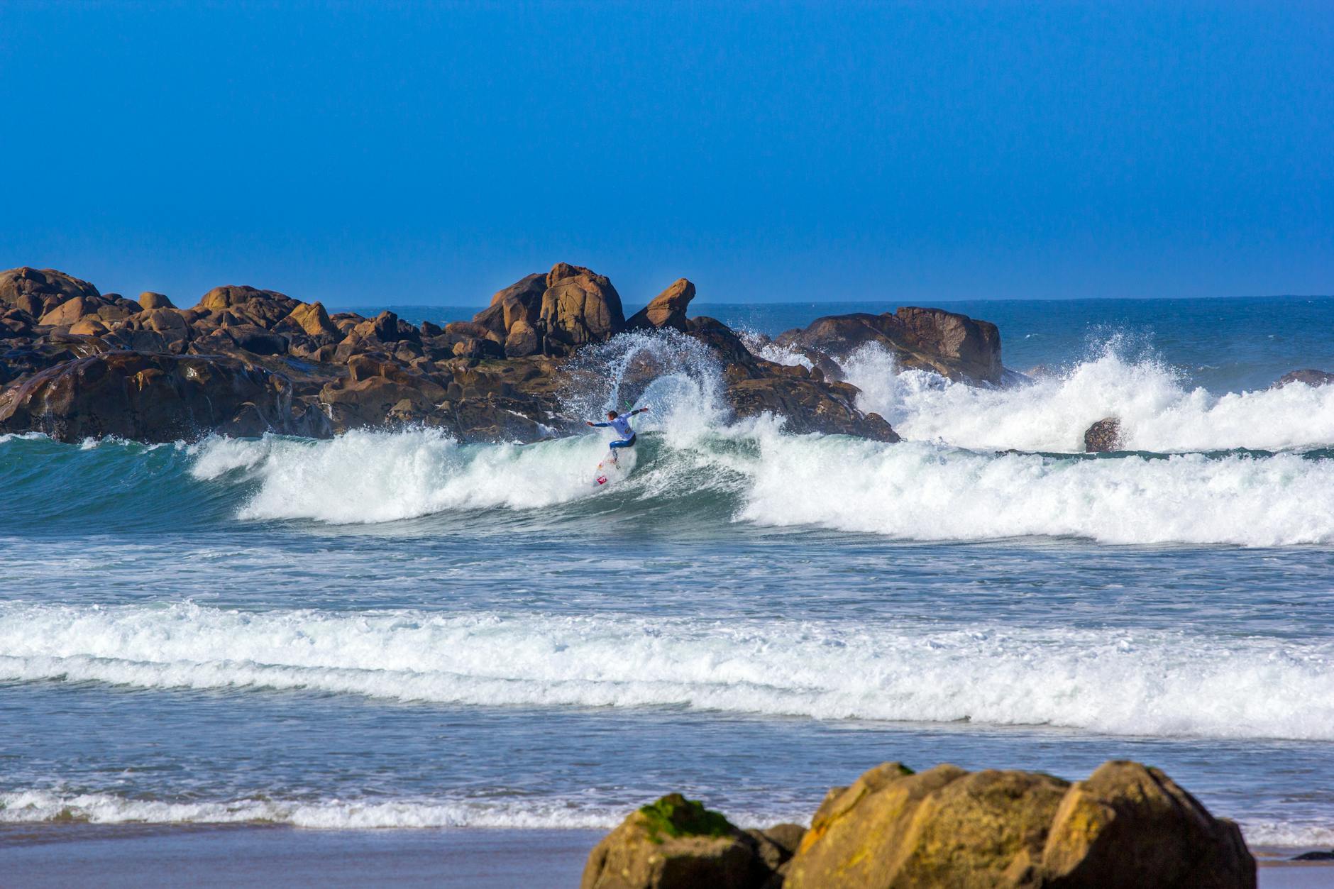 Surfer riding waves near Matosinhos in Porto