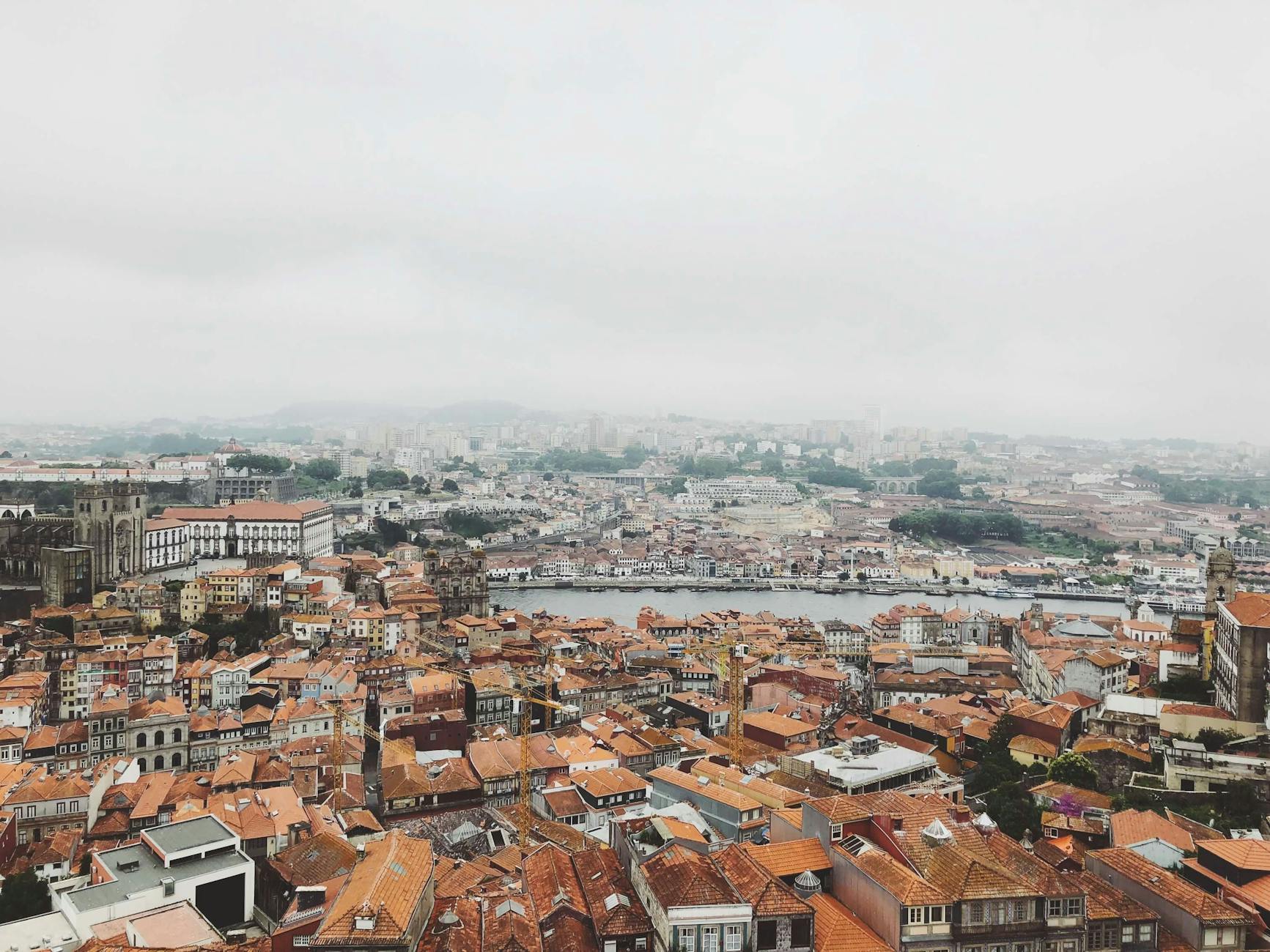 Aerial view of Porto rooftops and the Douro River in mist