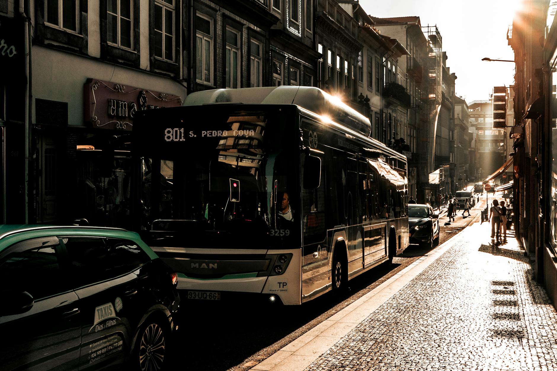 Traffic and evening light in Porto's historic streets