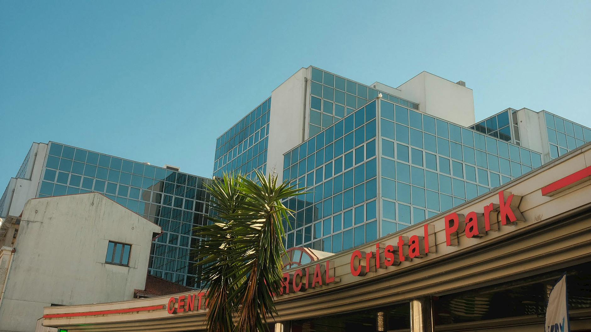 Glass facade commercial building in Porto under clear skies