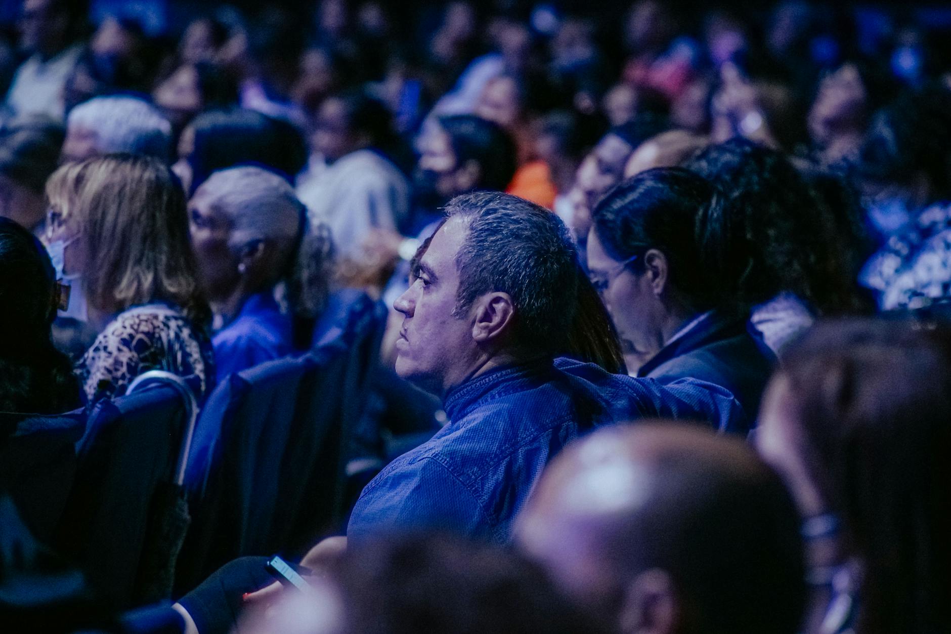 Large audience listening during an indoor conference event