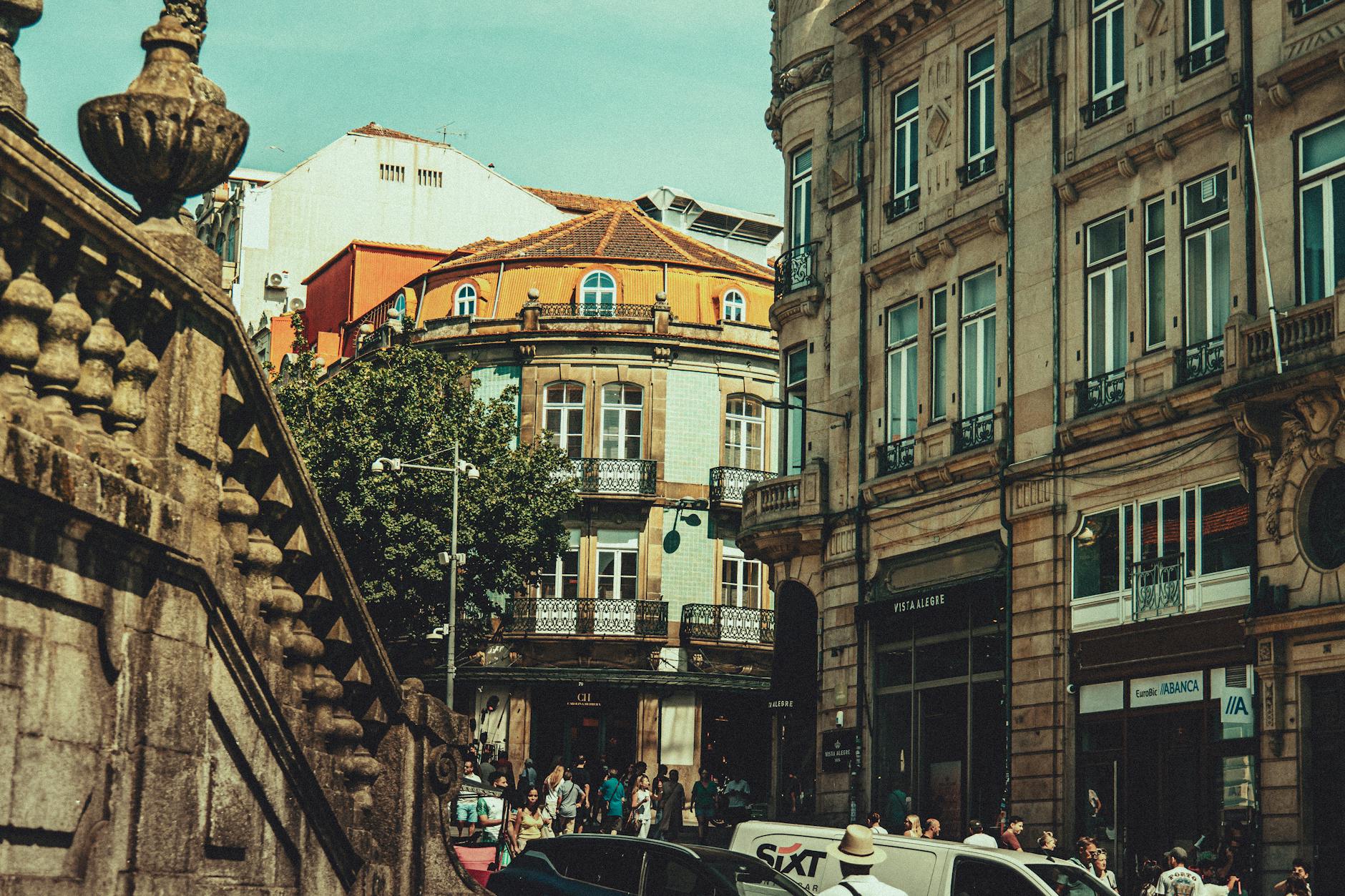 Busy Porto street with classic architecture and pedestrians