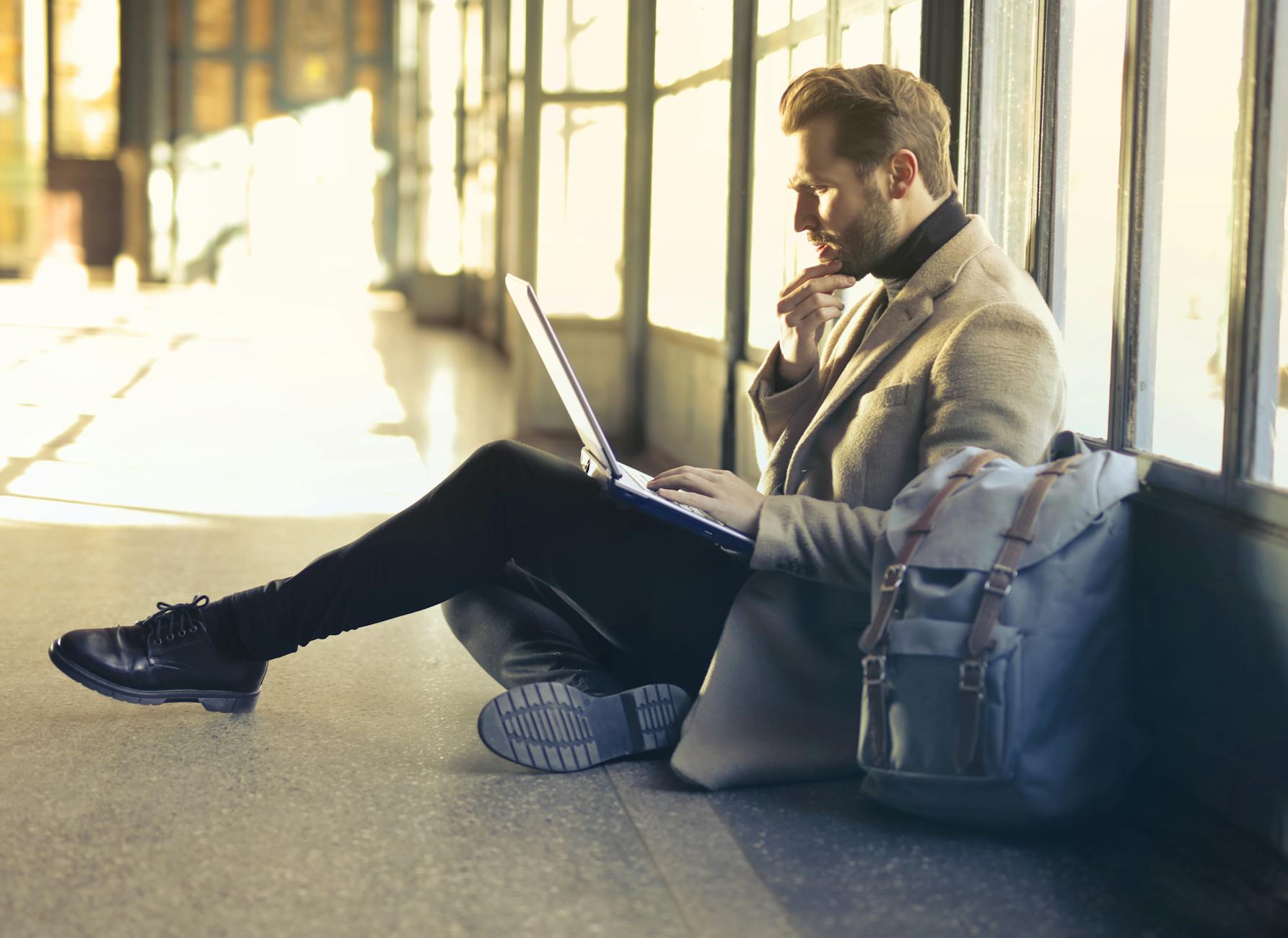 Business traveler using a laptop at an airport