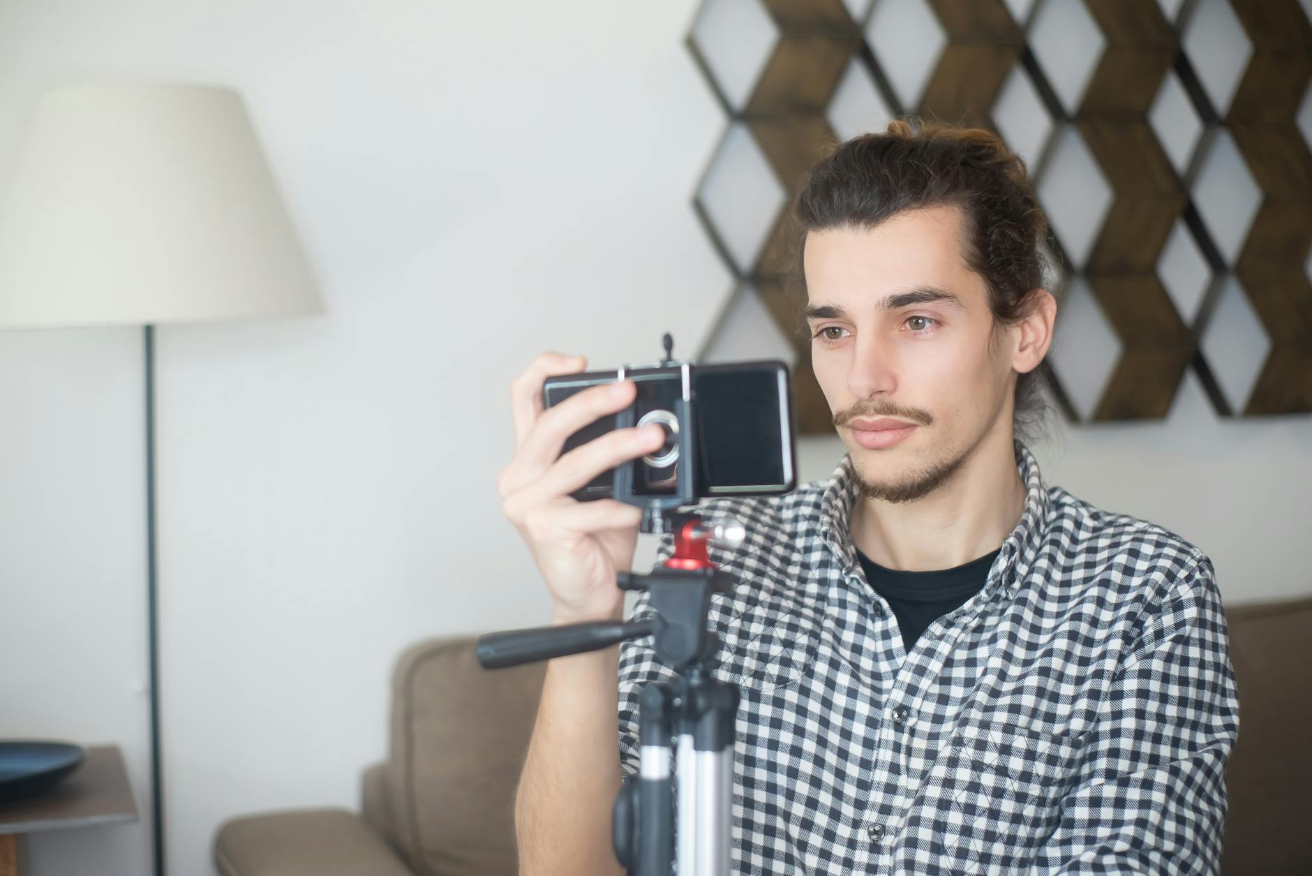 Creator using a smartphone and tripod indoors in Portugal