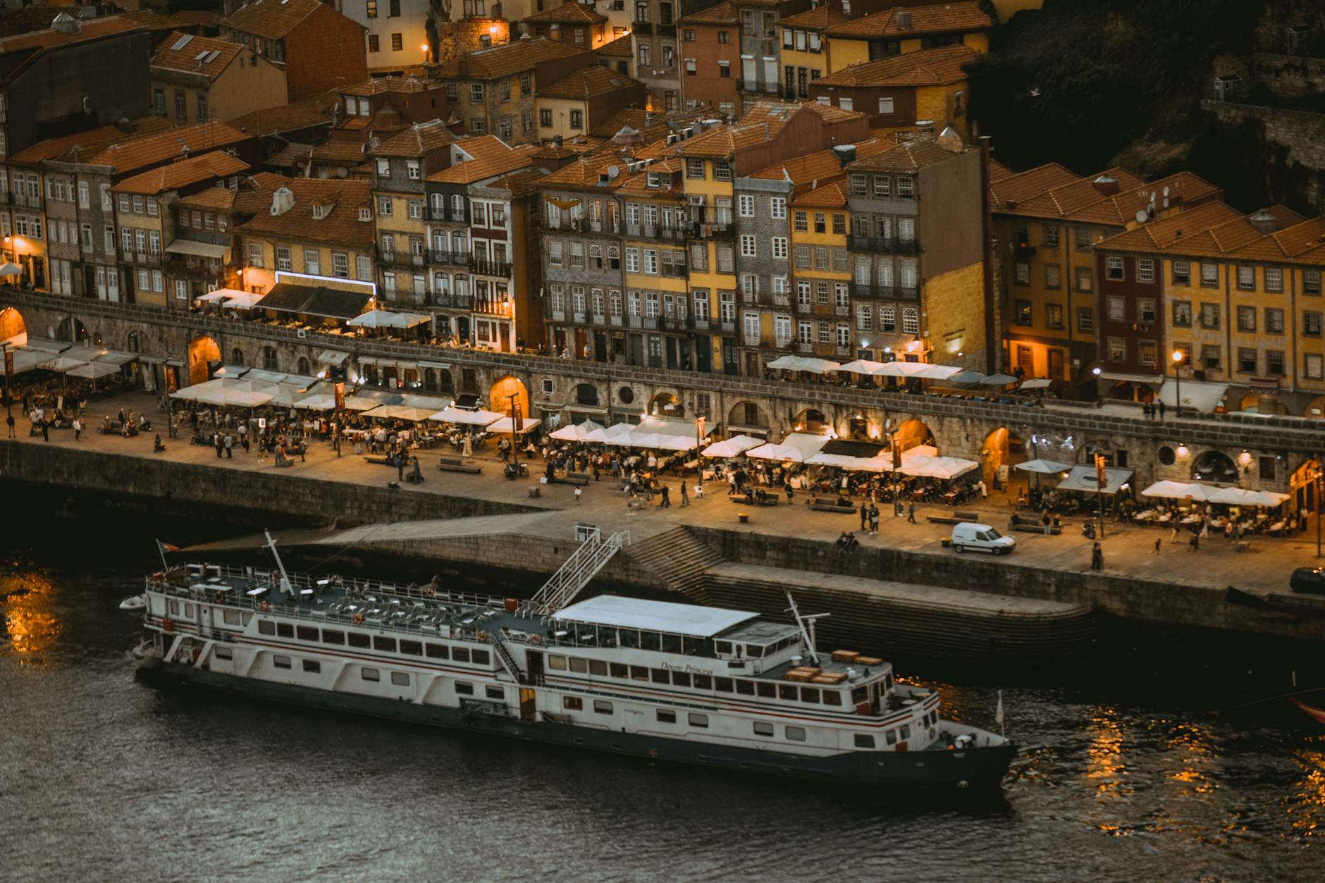 Porto riverside at night with a moored cruise ship and promenade