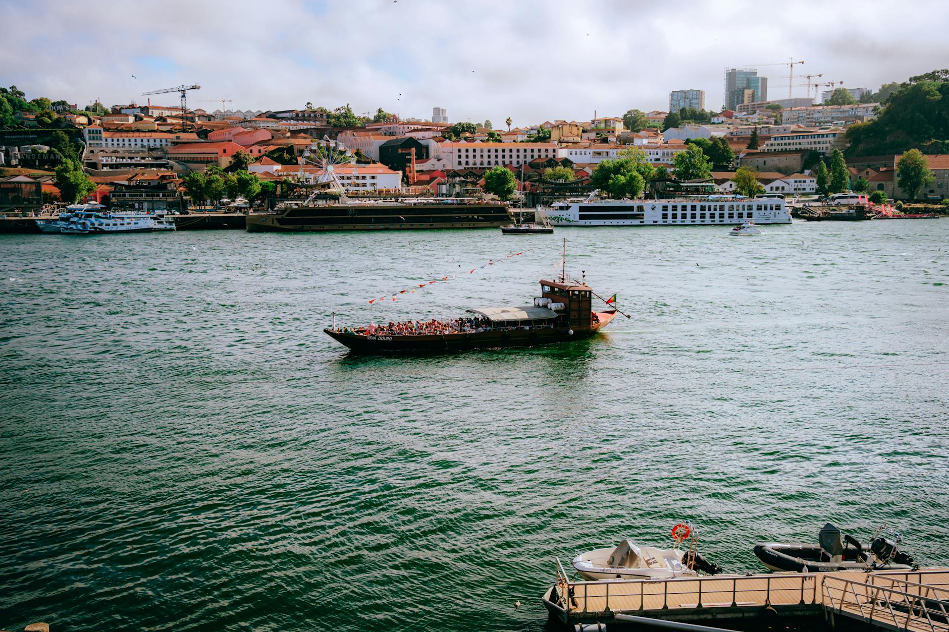Tourists cruising on the Douro River with Porto skyline in view