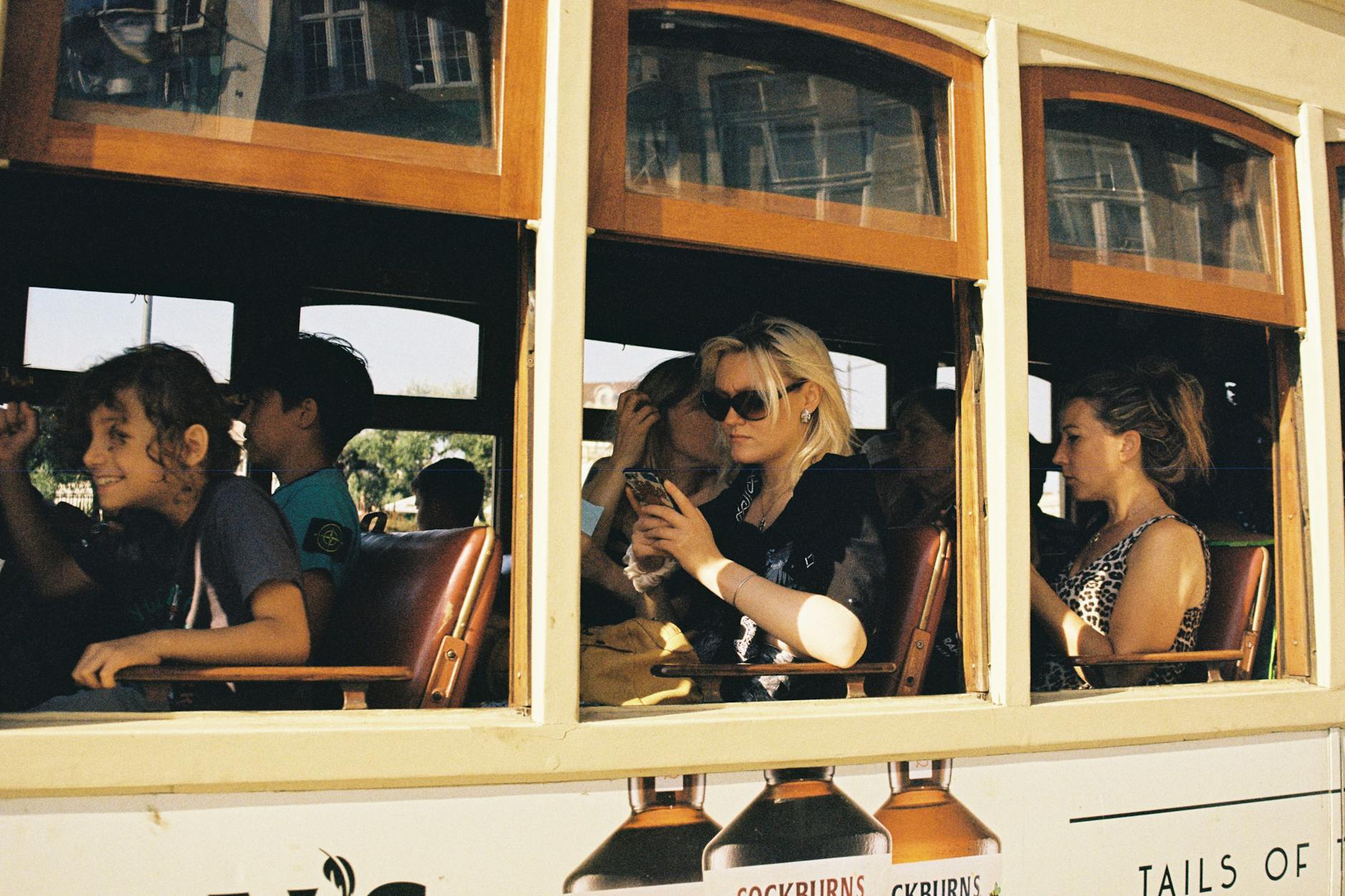 Passengers riding a historic tram through Porto streets