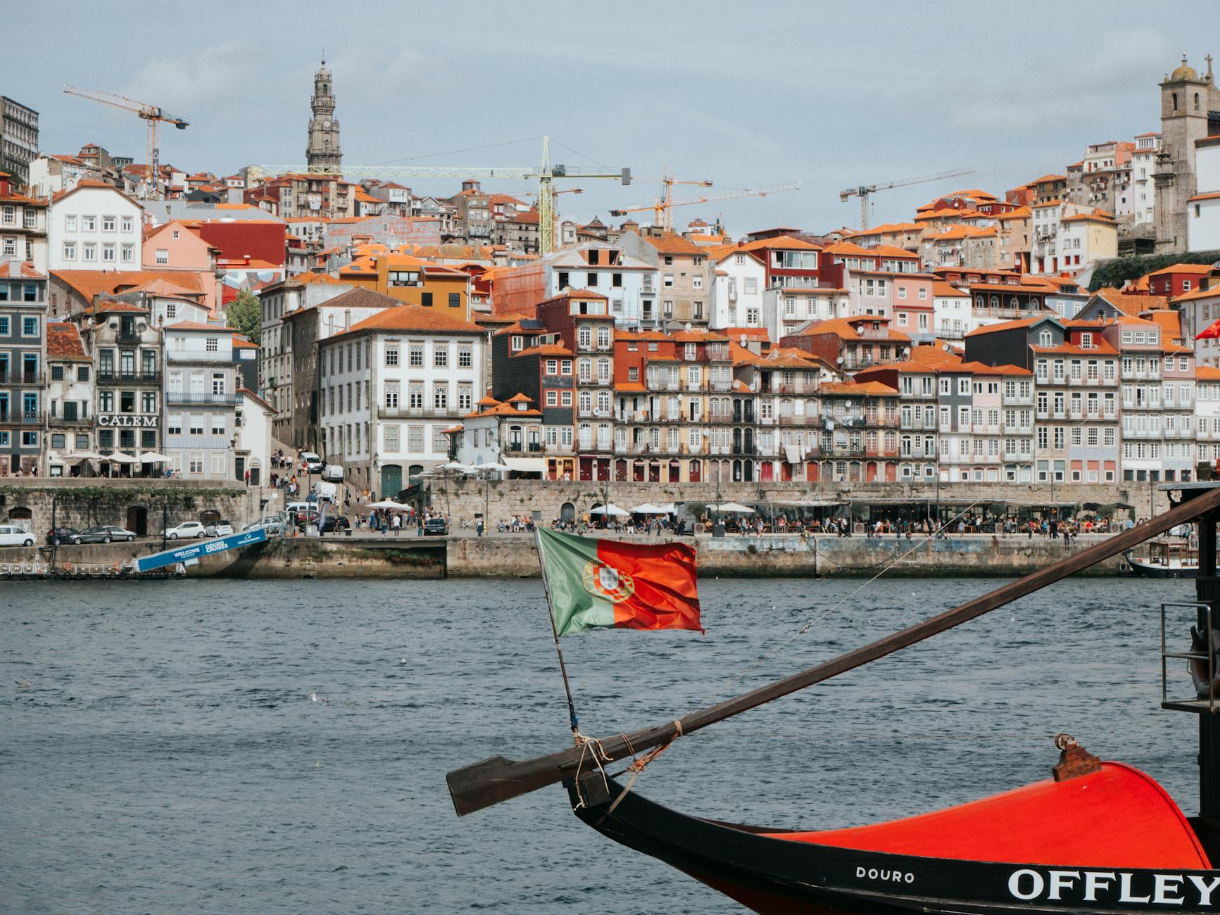 Colorful Ribeira District with Douro River and traditional boat