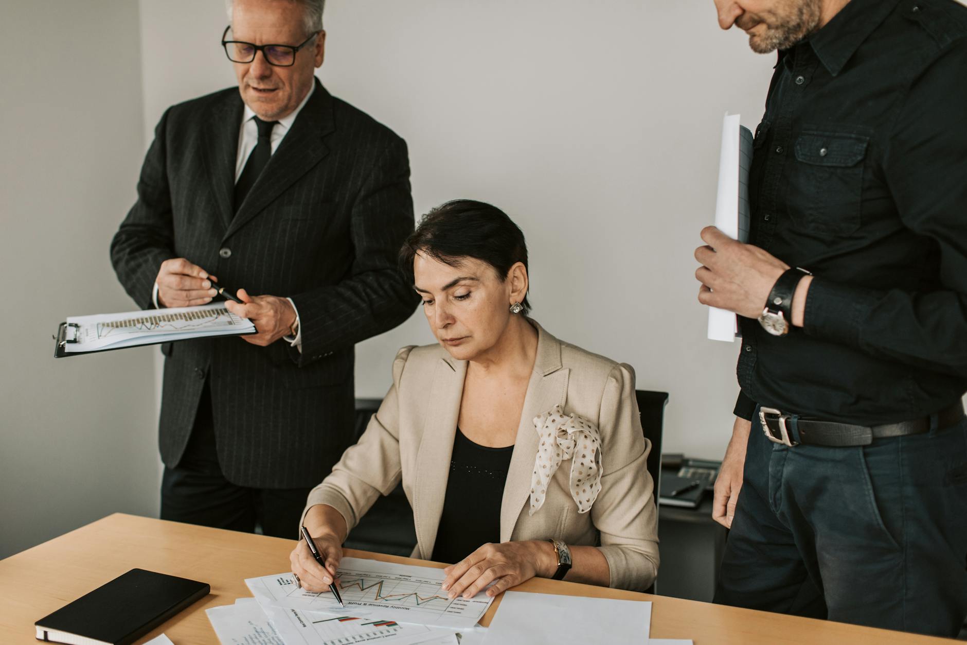 Business professionals collaborating on financial documents