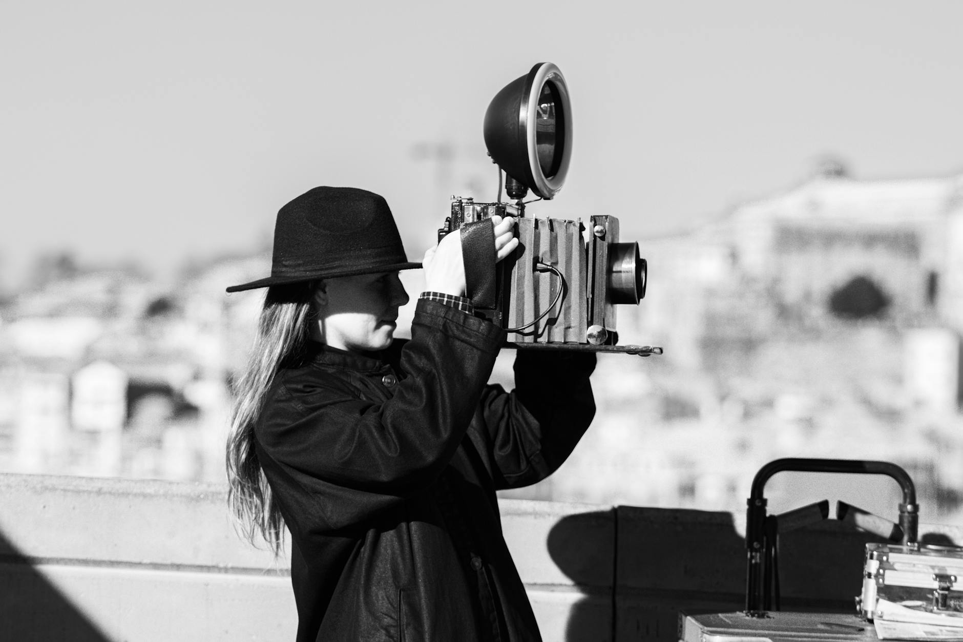 Person using a vintage camera in Porto