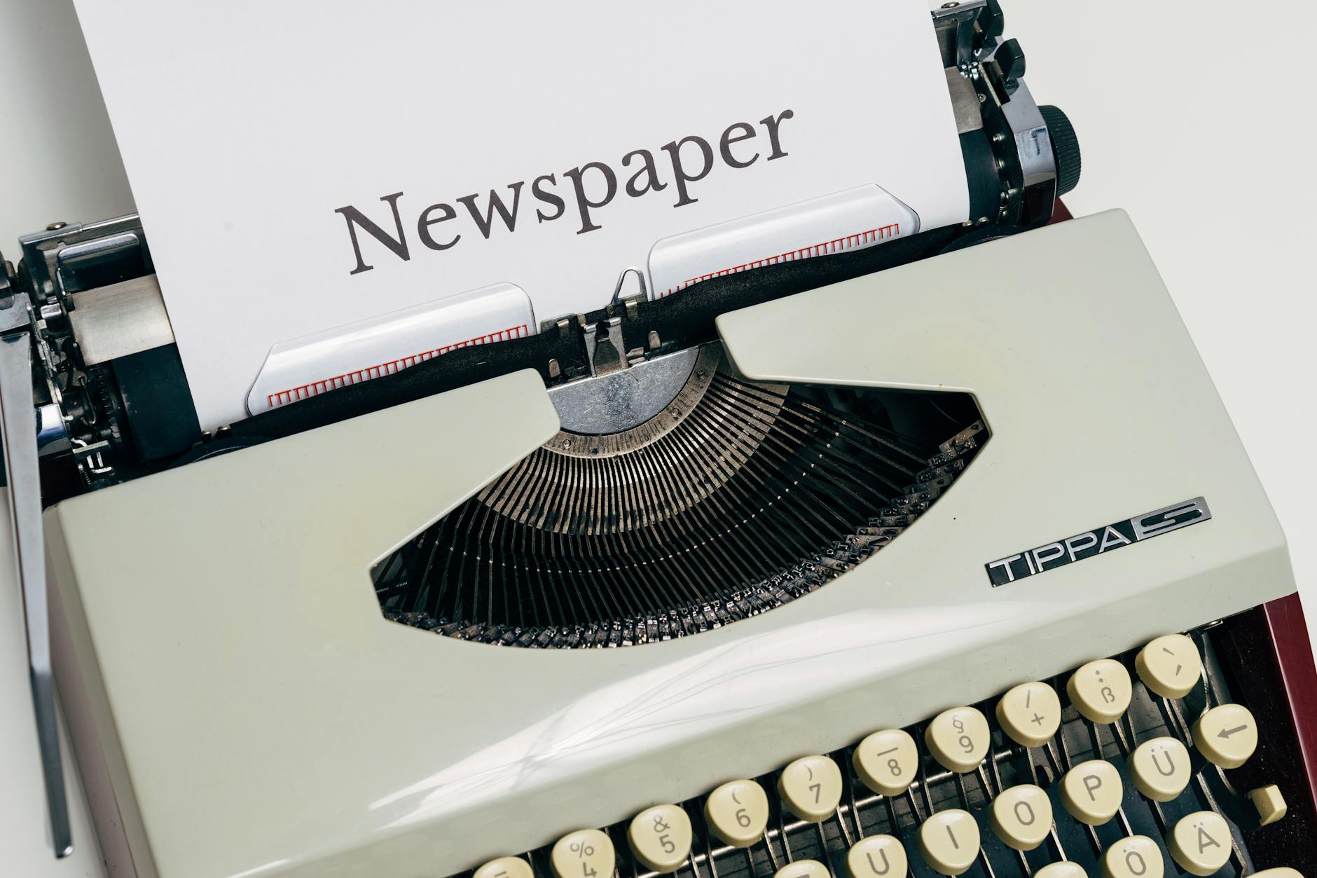 Vintage typewriter with newspaper text on the page