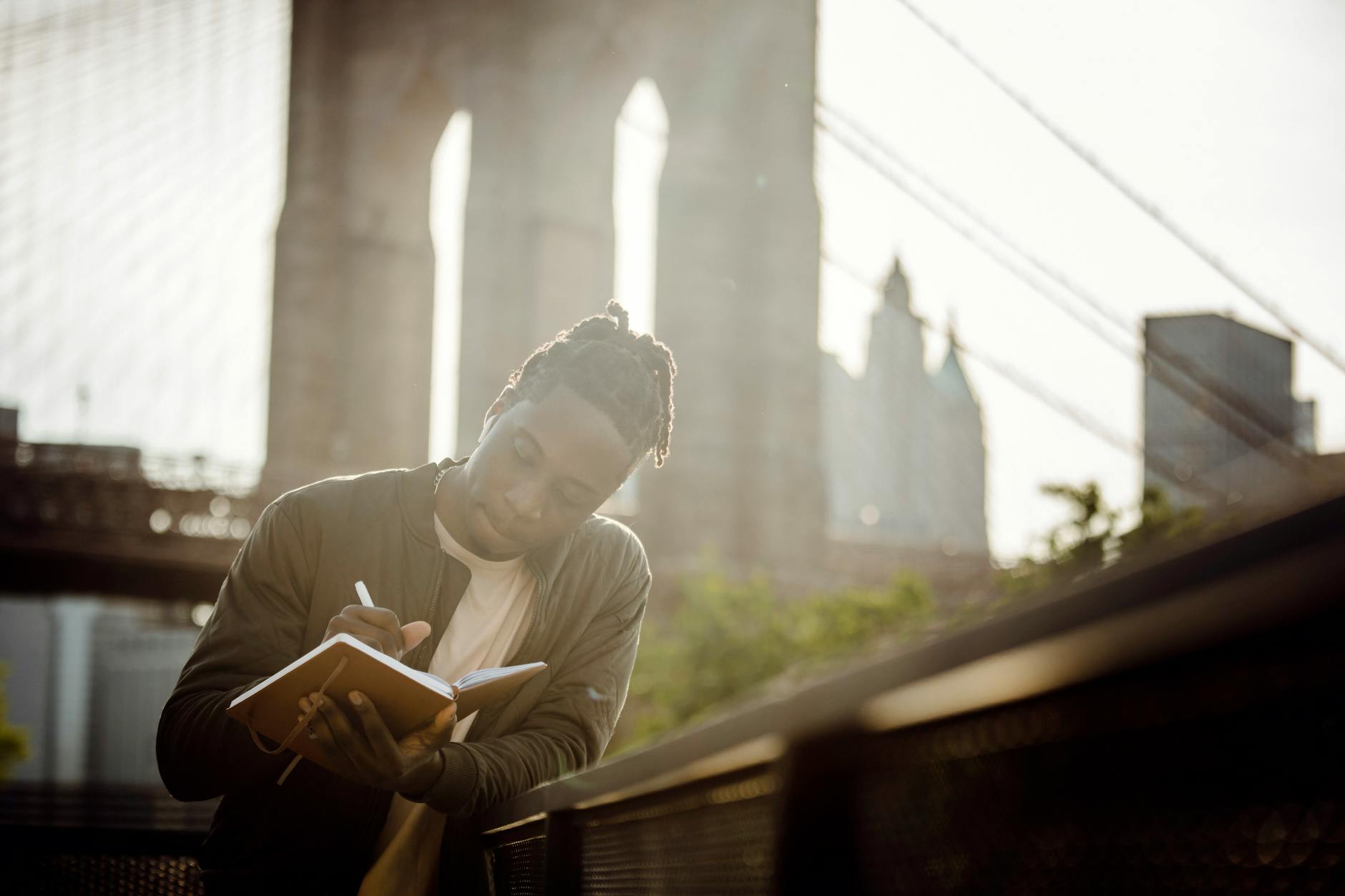 Journalist writing notes beside a riverbank