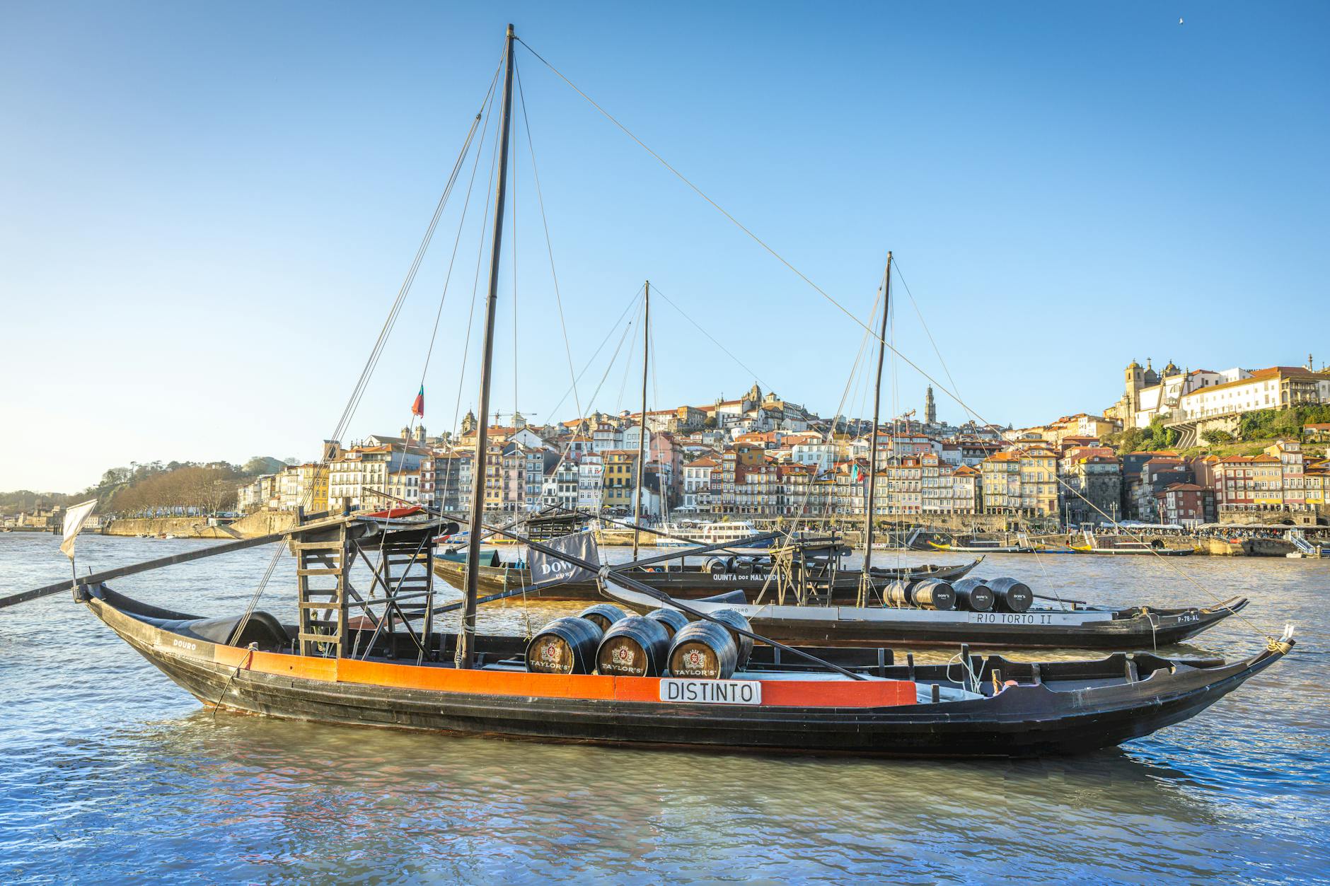 Rabelo boats with wine barrels on the Douro River in Porto