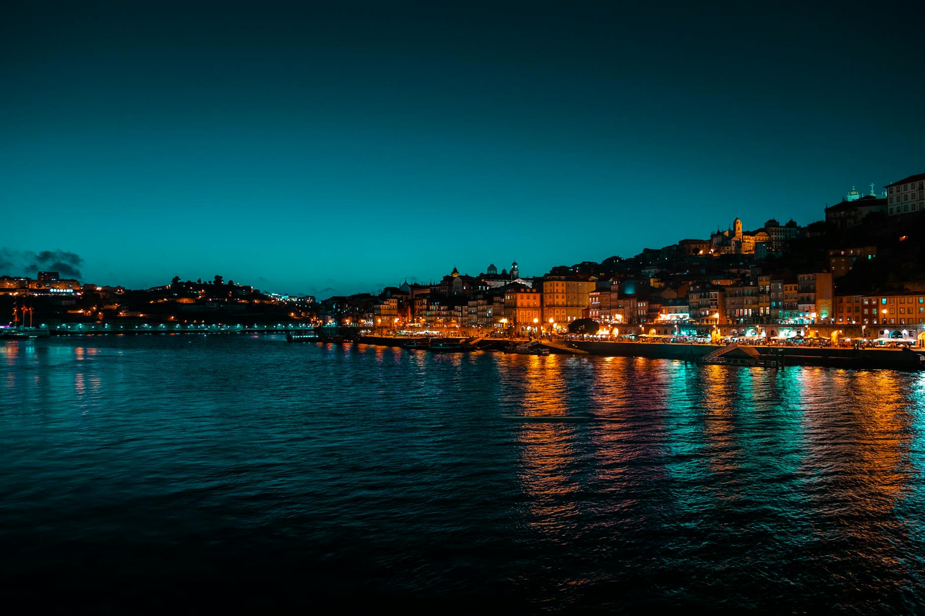Night view of Porto waterfront lights reflected on the Douro River