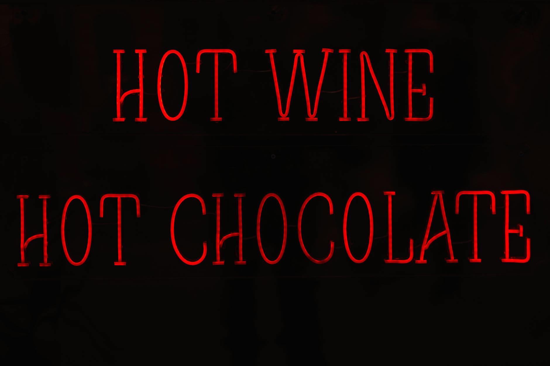 Red neon hot wine sign in Porto