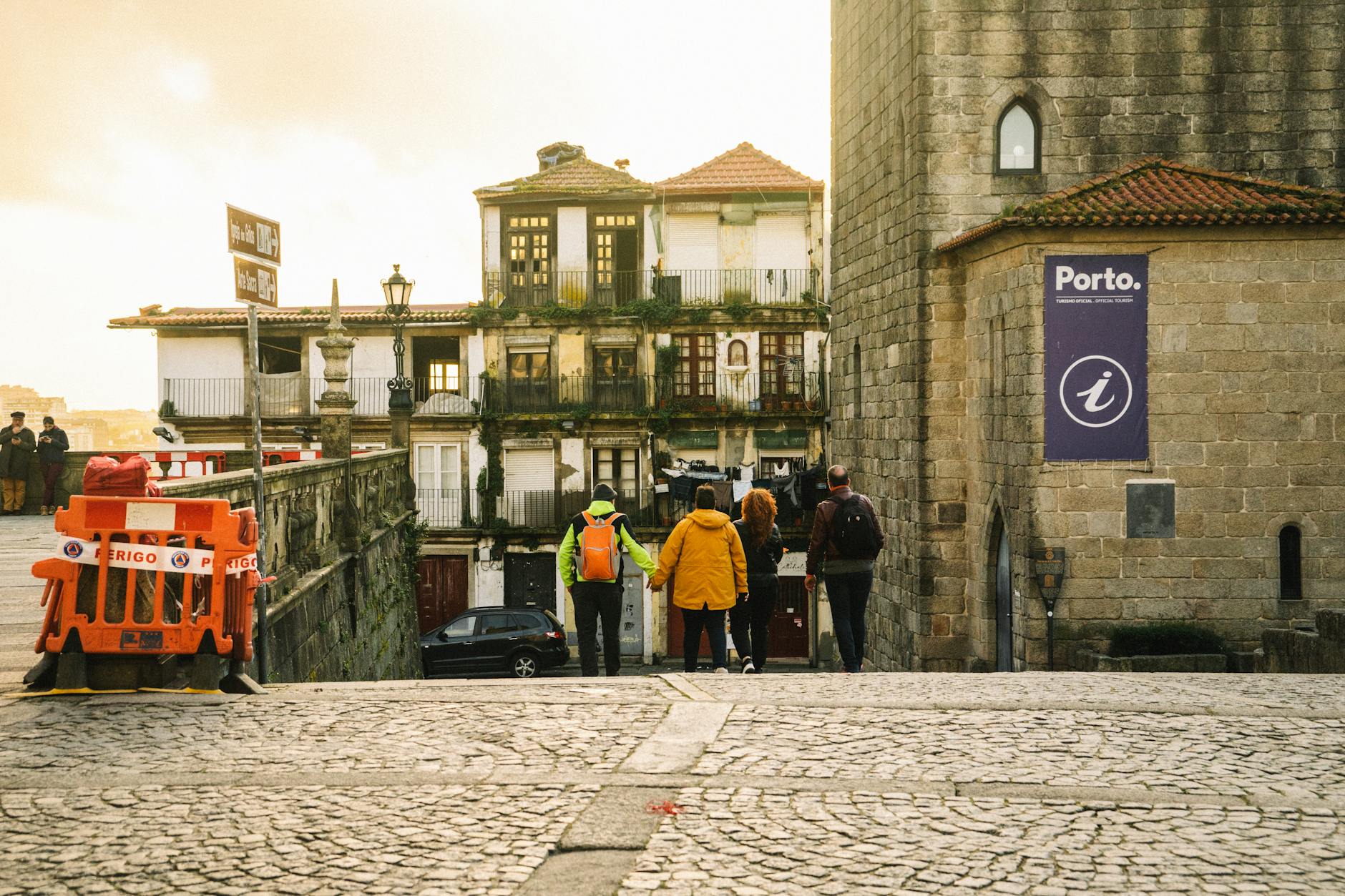 People walking down Porto cobblestone streets near historic buildings